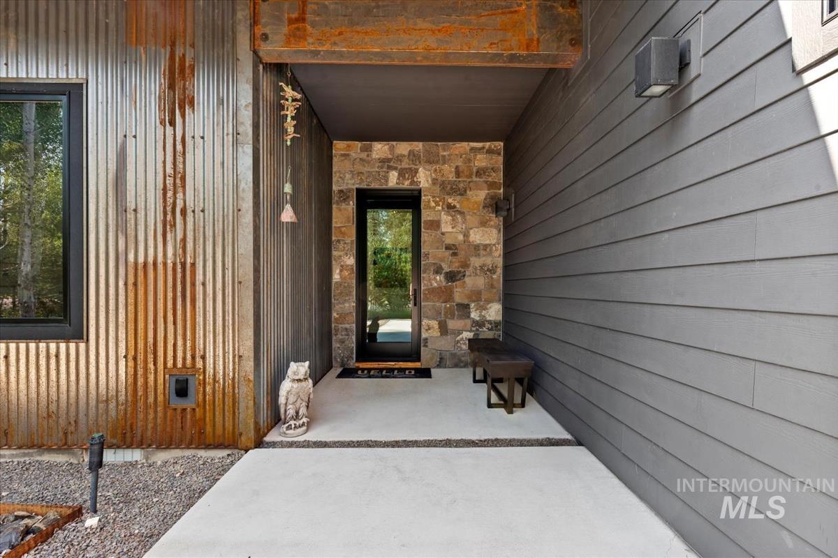 Doorway to property with stone siding