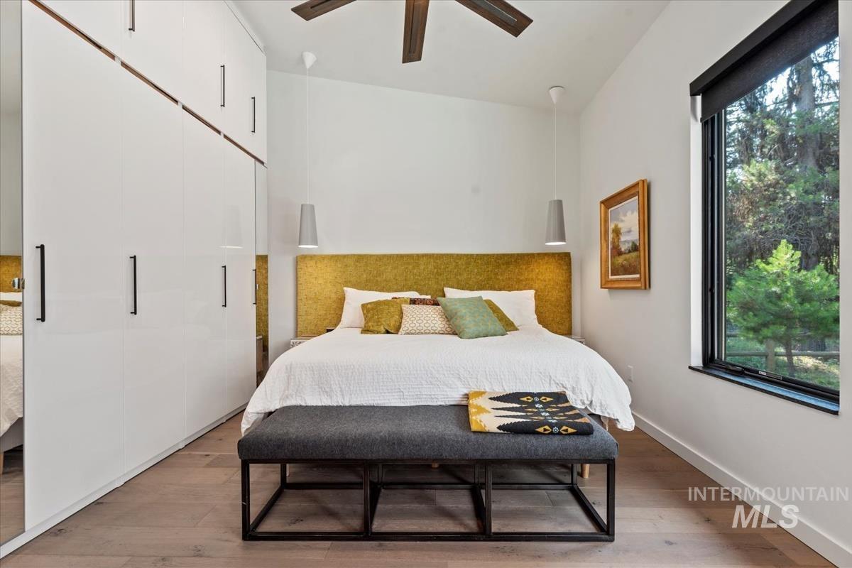 Bedroom with light wood finished floors and baseboards