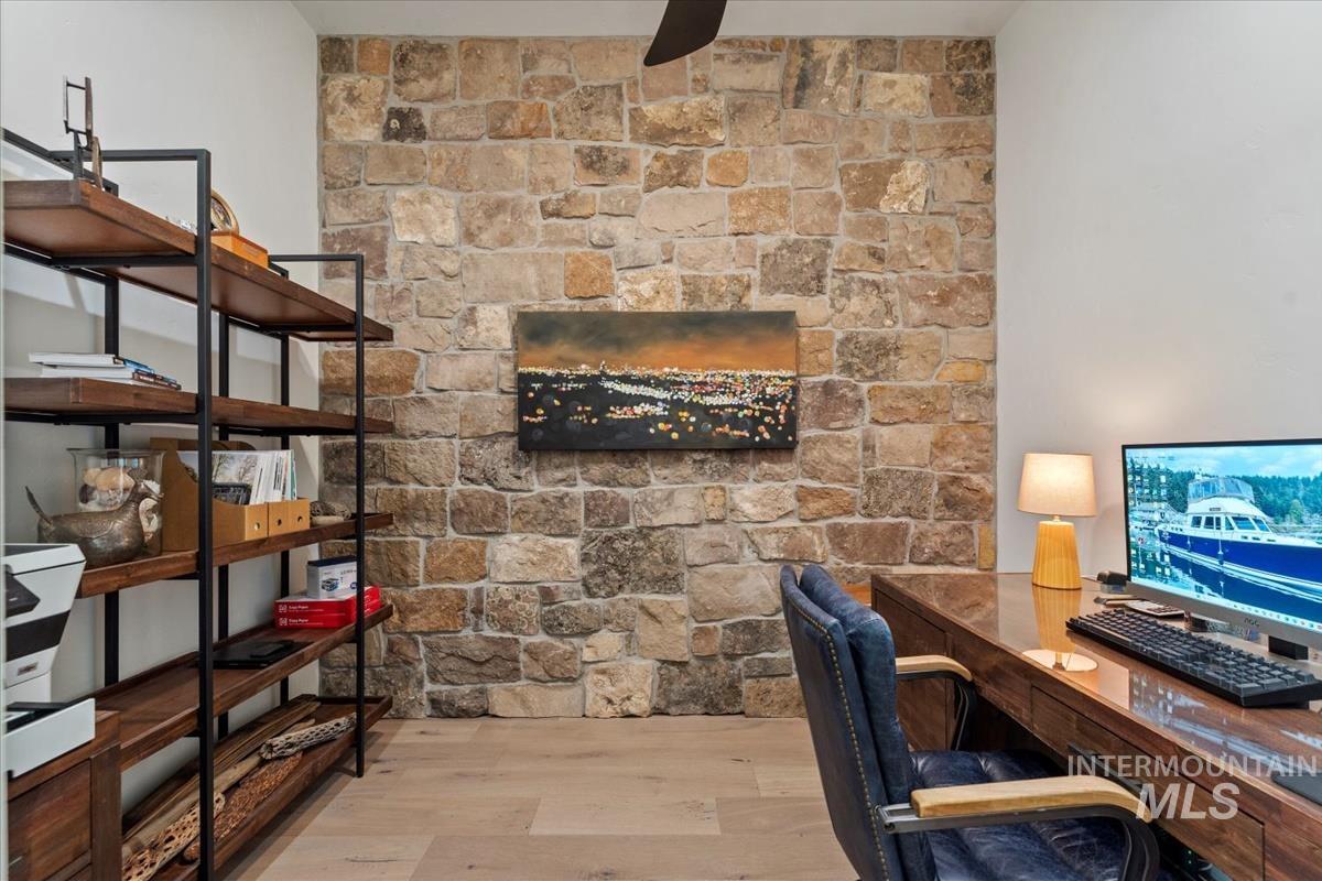 Home office with wood finished floors and a ceiling fan