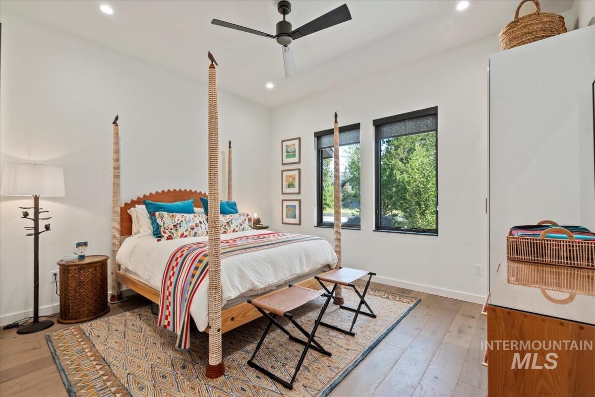 Bedroom with light wood-style floors, recessed lighting, and a ceiling fan
