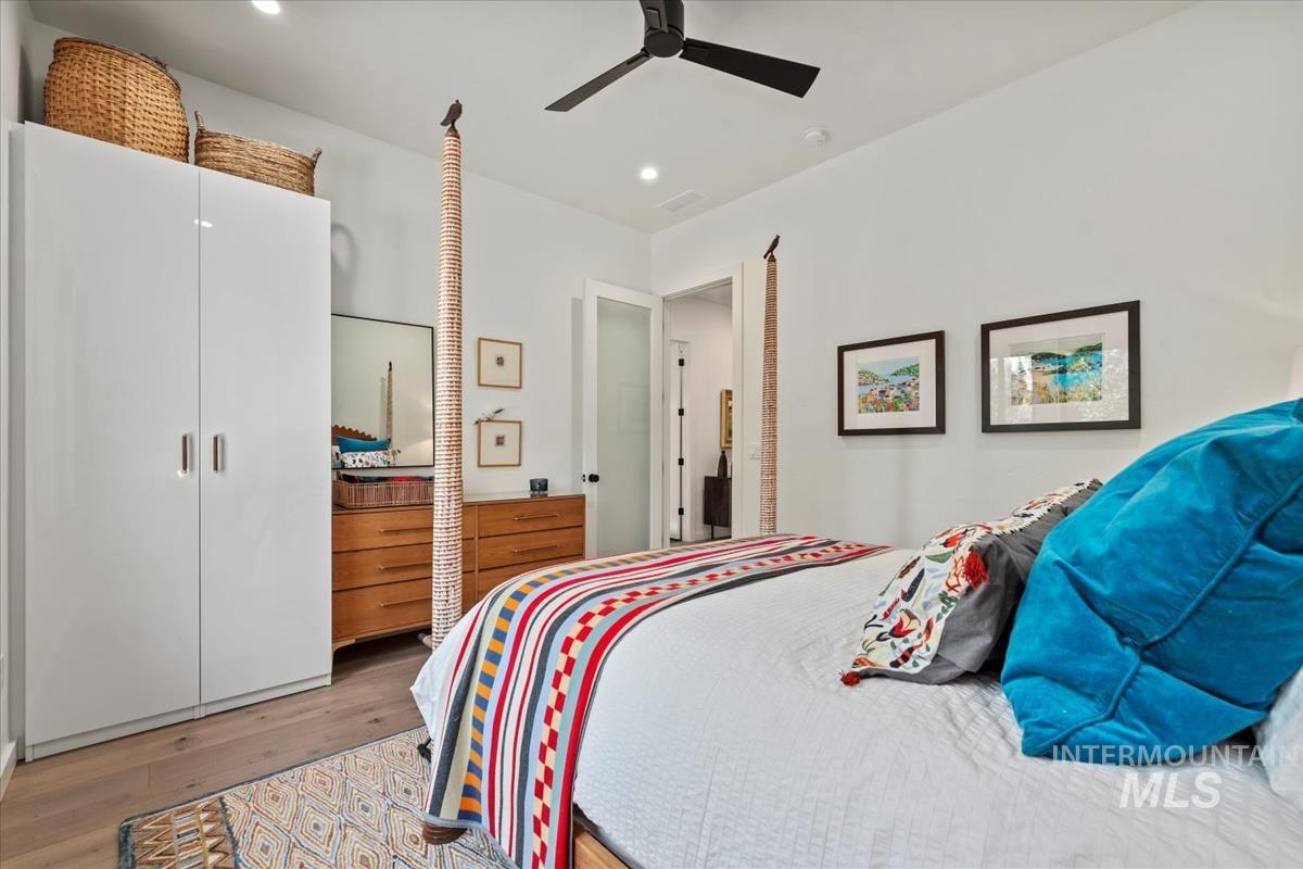 Bedroom featuring light wood-type flooring, recessed lighting, and a ceiling fan