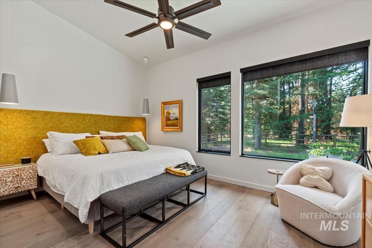 Bedroom with wood finished floors and baseboards