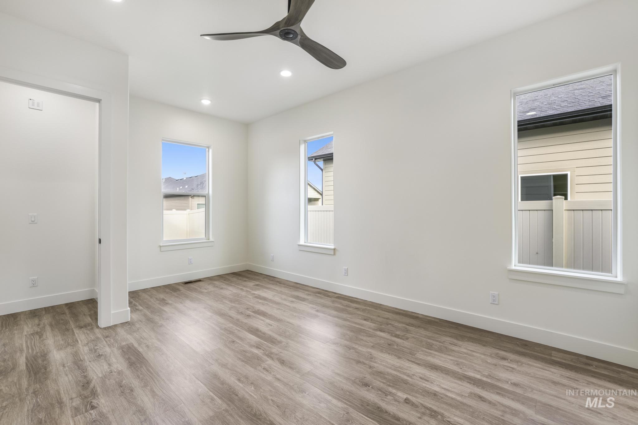 Unfurnished bedroom featuring light wood-type flooring, ceiling fan, and recessed lighting
