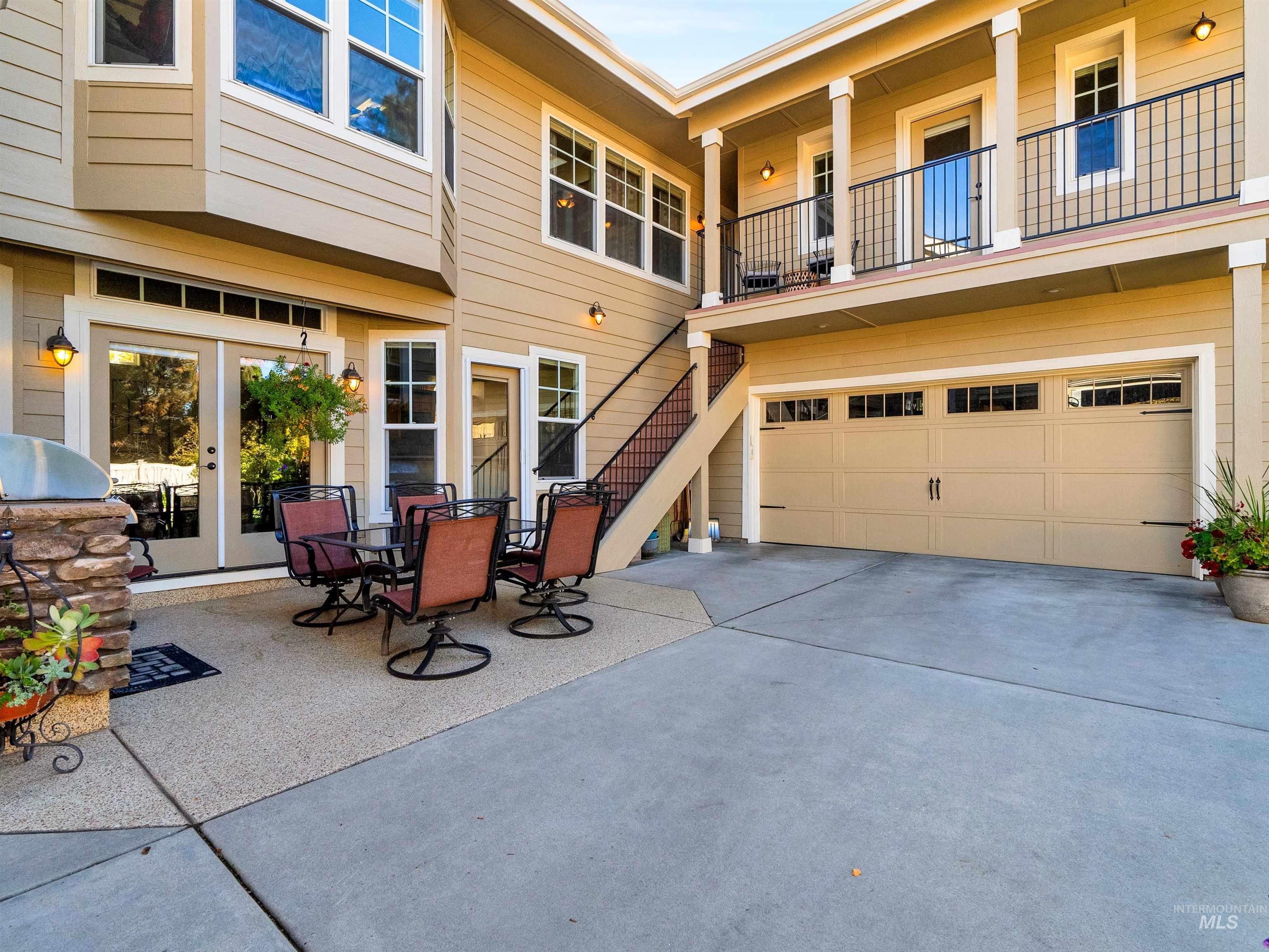 Patio / terrace with stairs, concrete driveway, and an attached garage