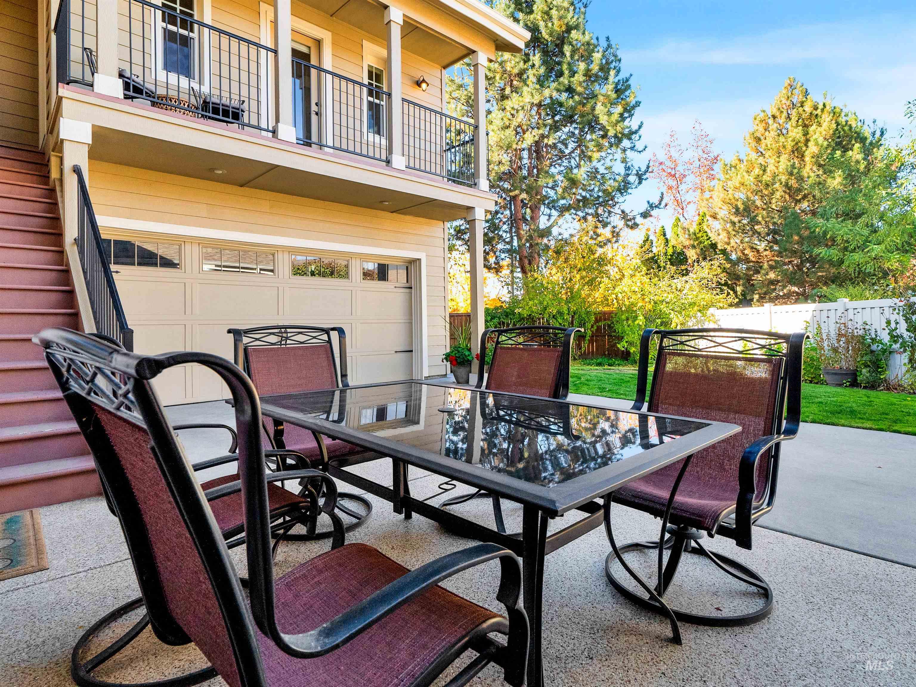 Patio / terrace with outdoor dining area, a patio area, and an attached garage