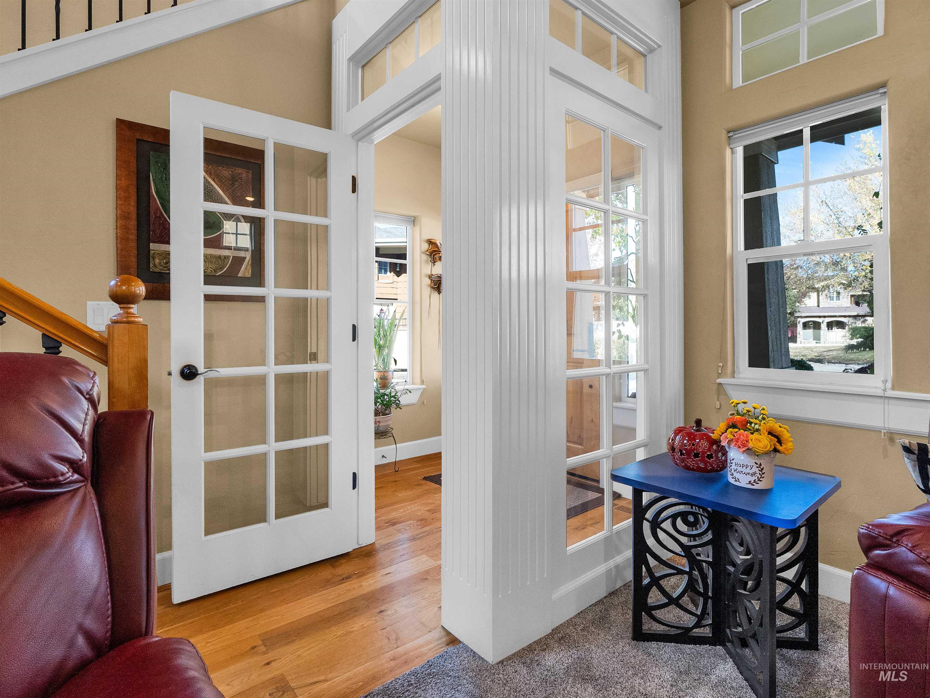 Doorway featuring healthy amount of natural light, french doors, and wood finished floors