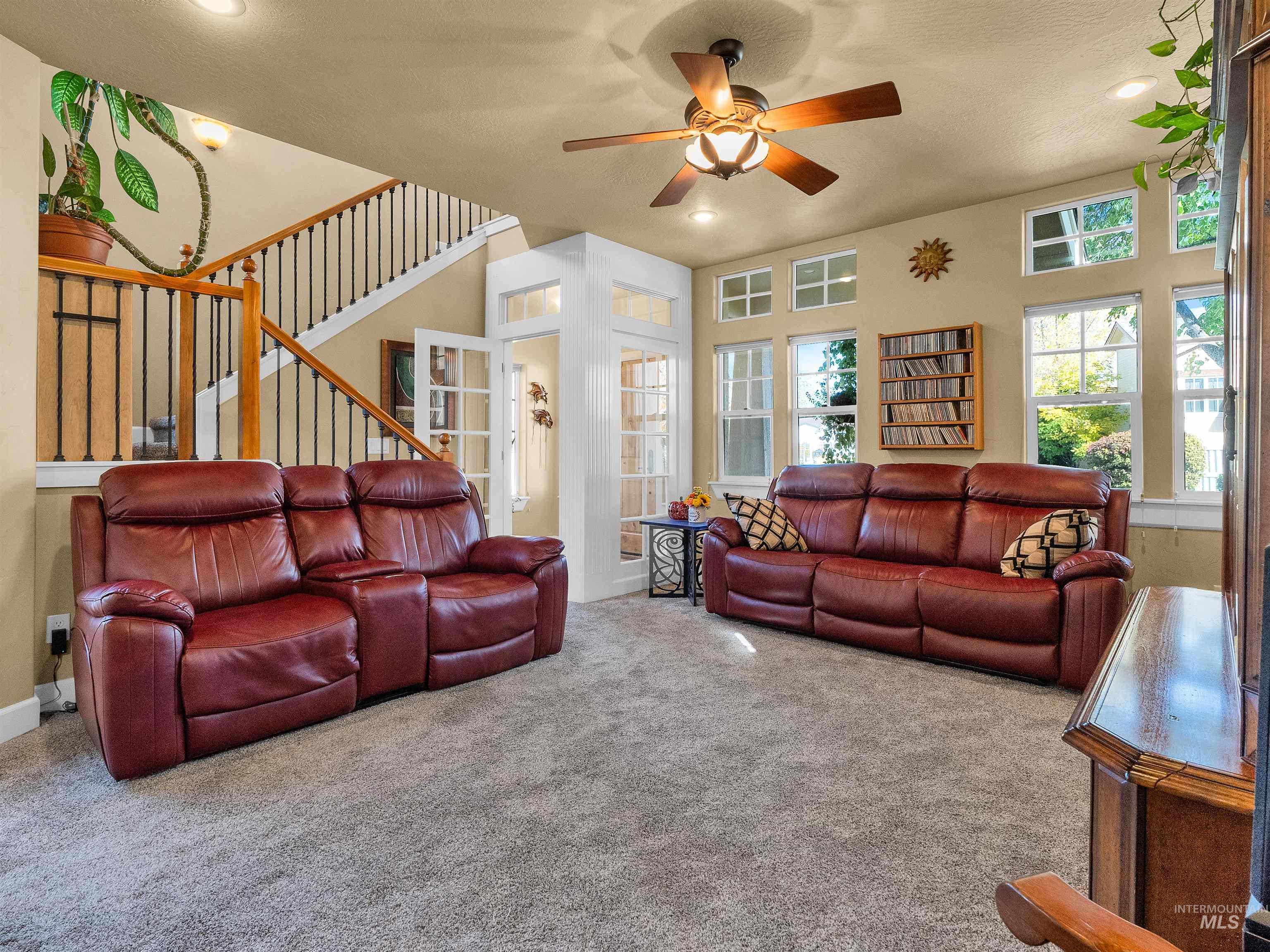 Living room with carpet flooring, stairway, ceiling fan, recessed lighting, and french doors
