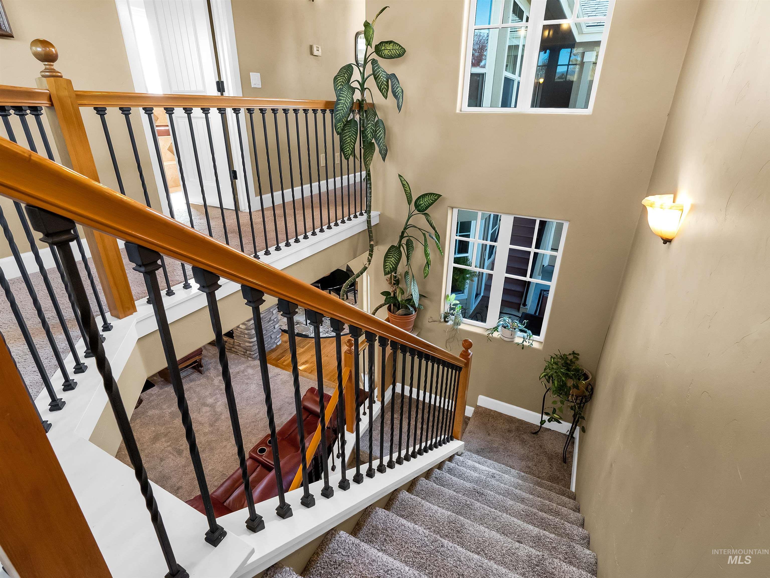 Stairway with carpet floors and a towering ceiling
