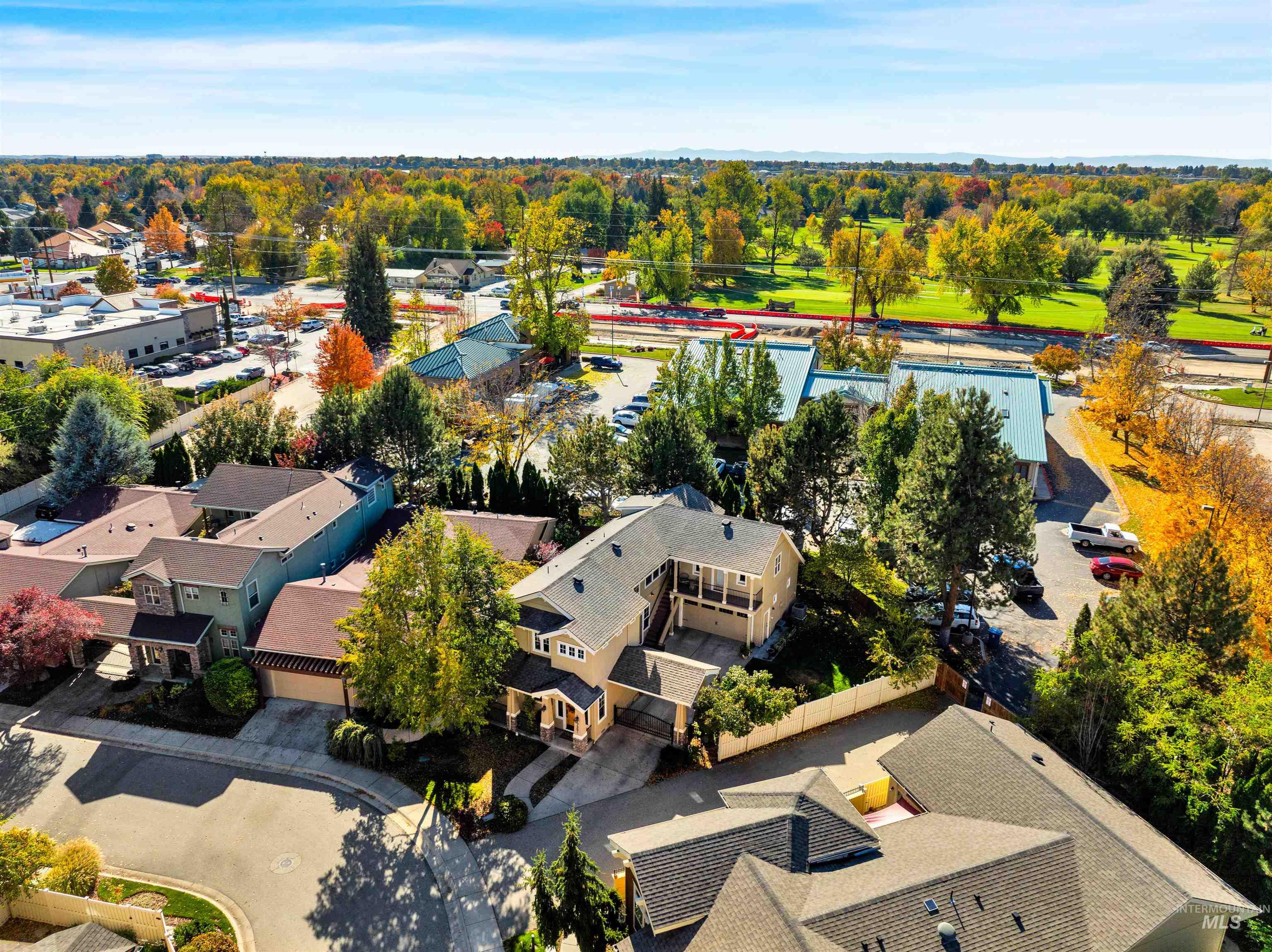 Aerial view of residential area featuring a tree filled landscape