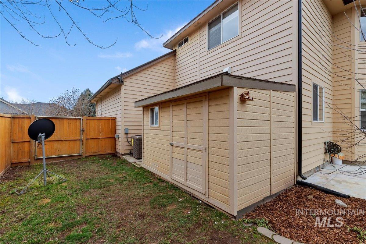 View of property exterior featuring a gate and a fenced backyard