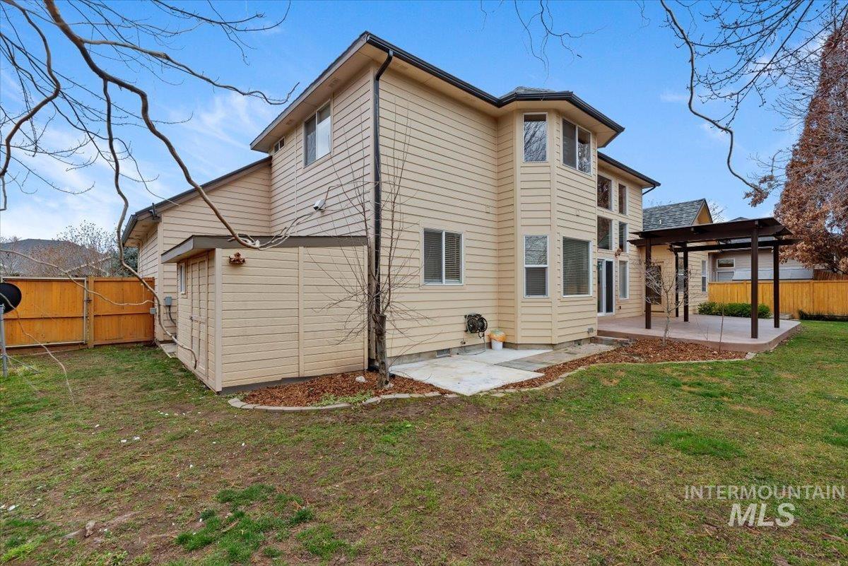 Back of house featuring a fenced backyard, a patio, and a gate