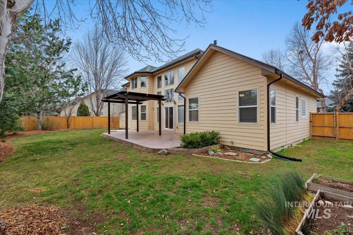 Rear view of property featuring a fenced backyard and a patio area