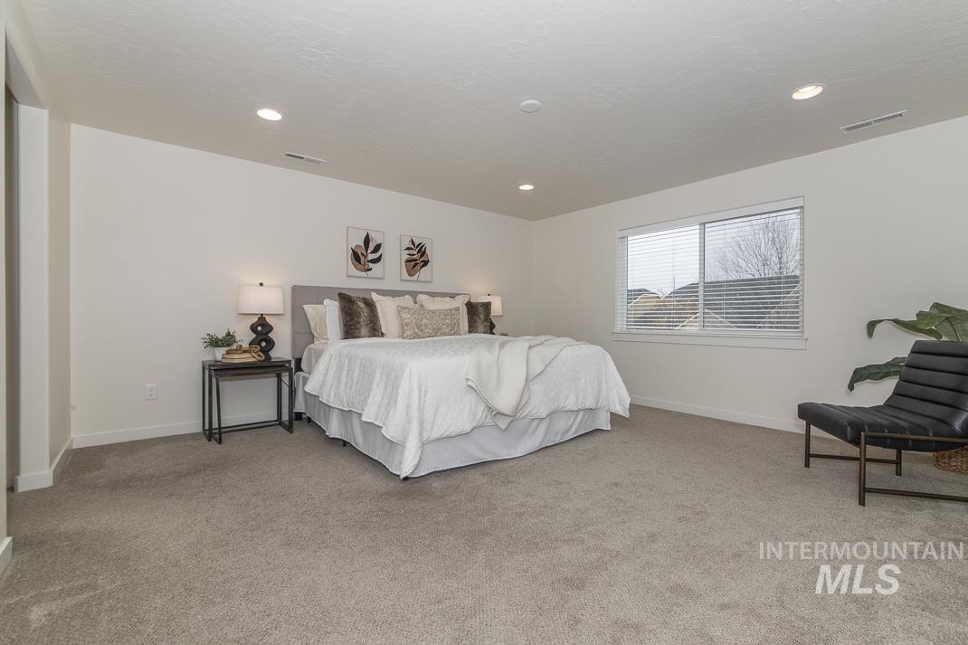 Bedroom featuring light colored carpet and recessed lighting