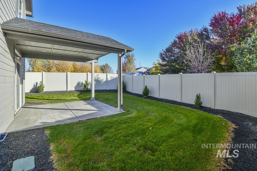 Fenced backyard with a patio area
