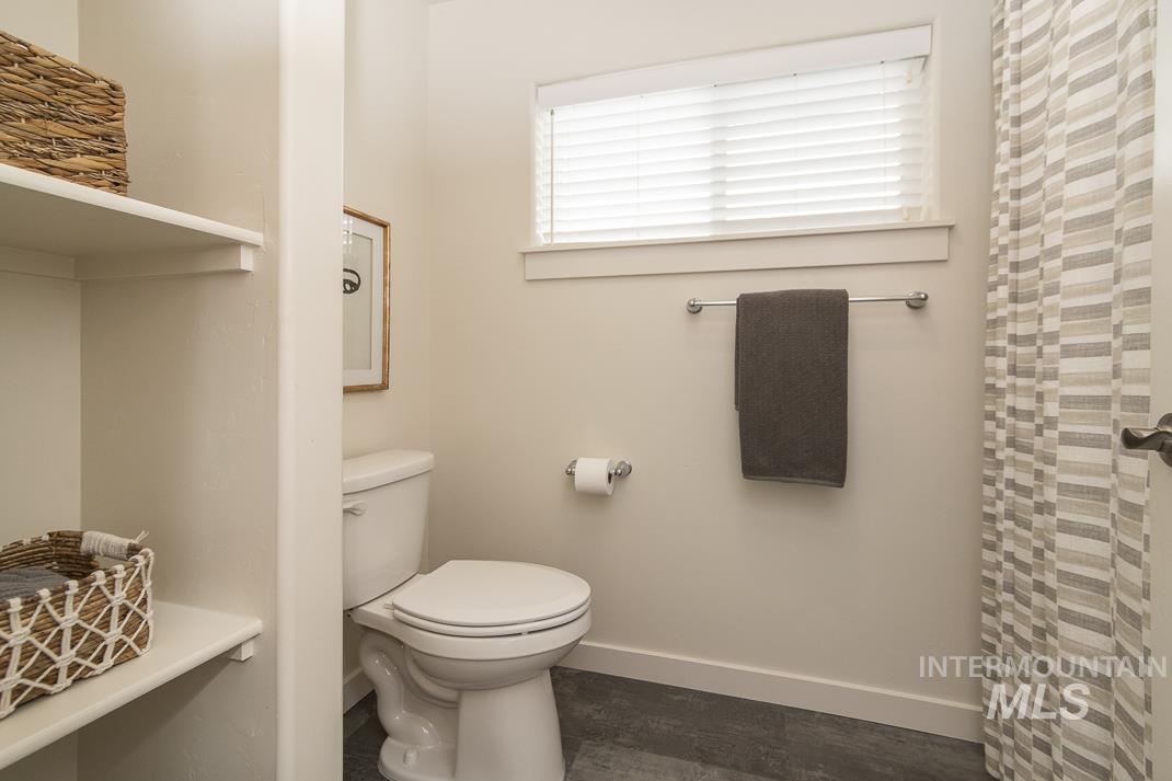Full bathroom featuring baseboards and a shower with curtain