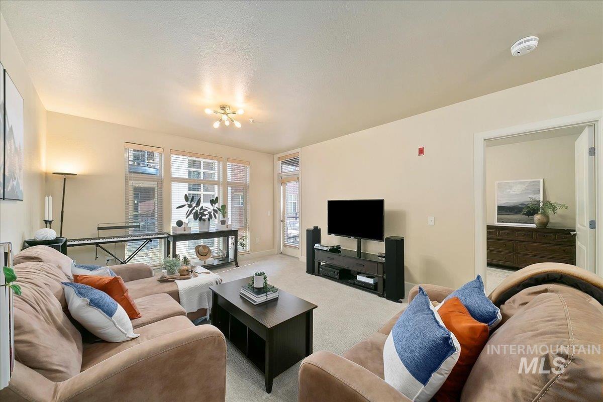 Living room with carpet floors and baseboards