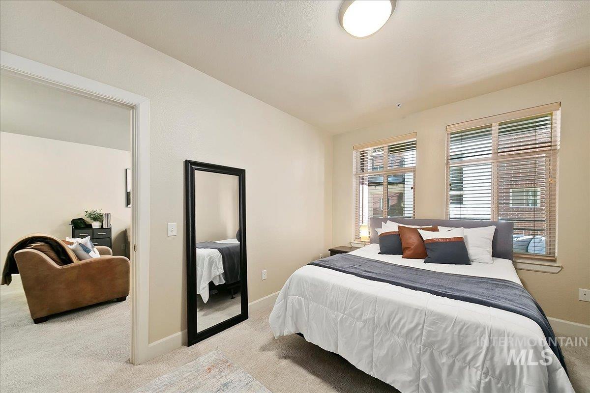 Carpeted bedroom featuring baseboards