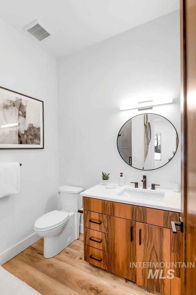 Bathroom with light wood-style flooring and vanity