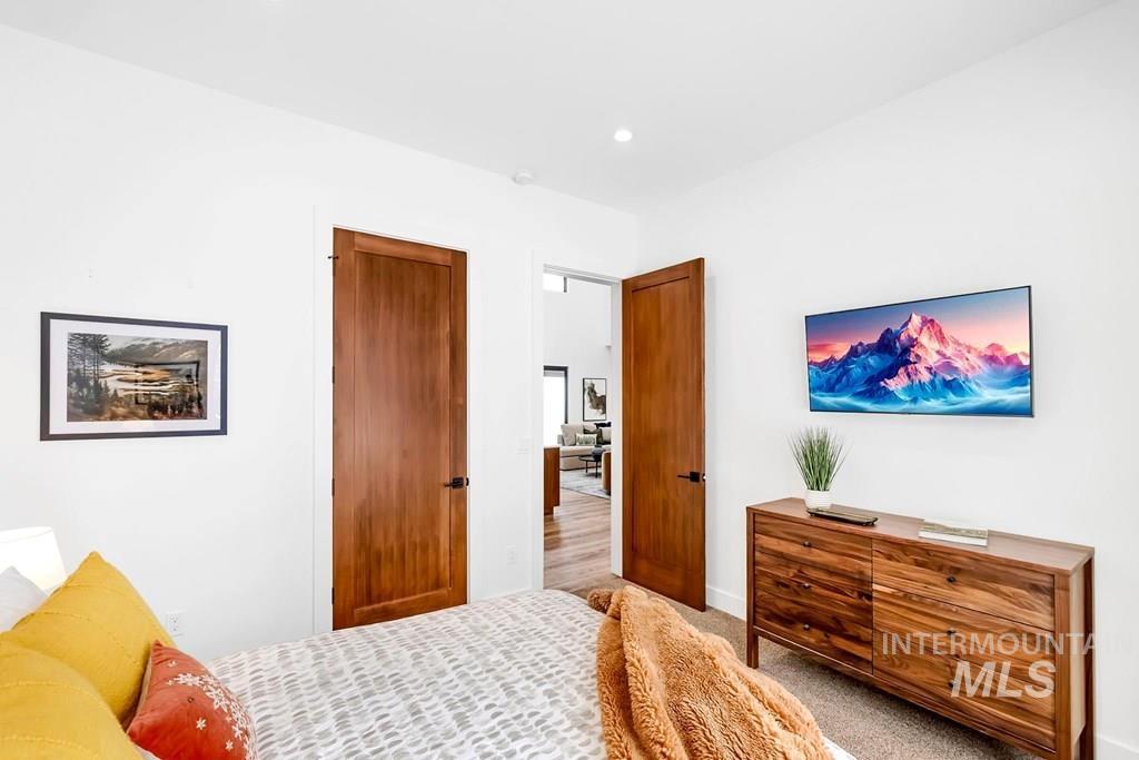 Carpeted bedroom featuring recessed lighting and baseboards