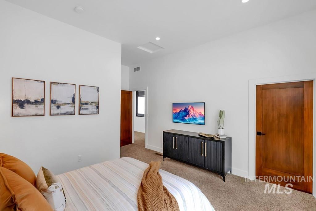 Carpeted bedroom featuring recessed lighting and baseboards
