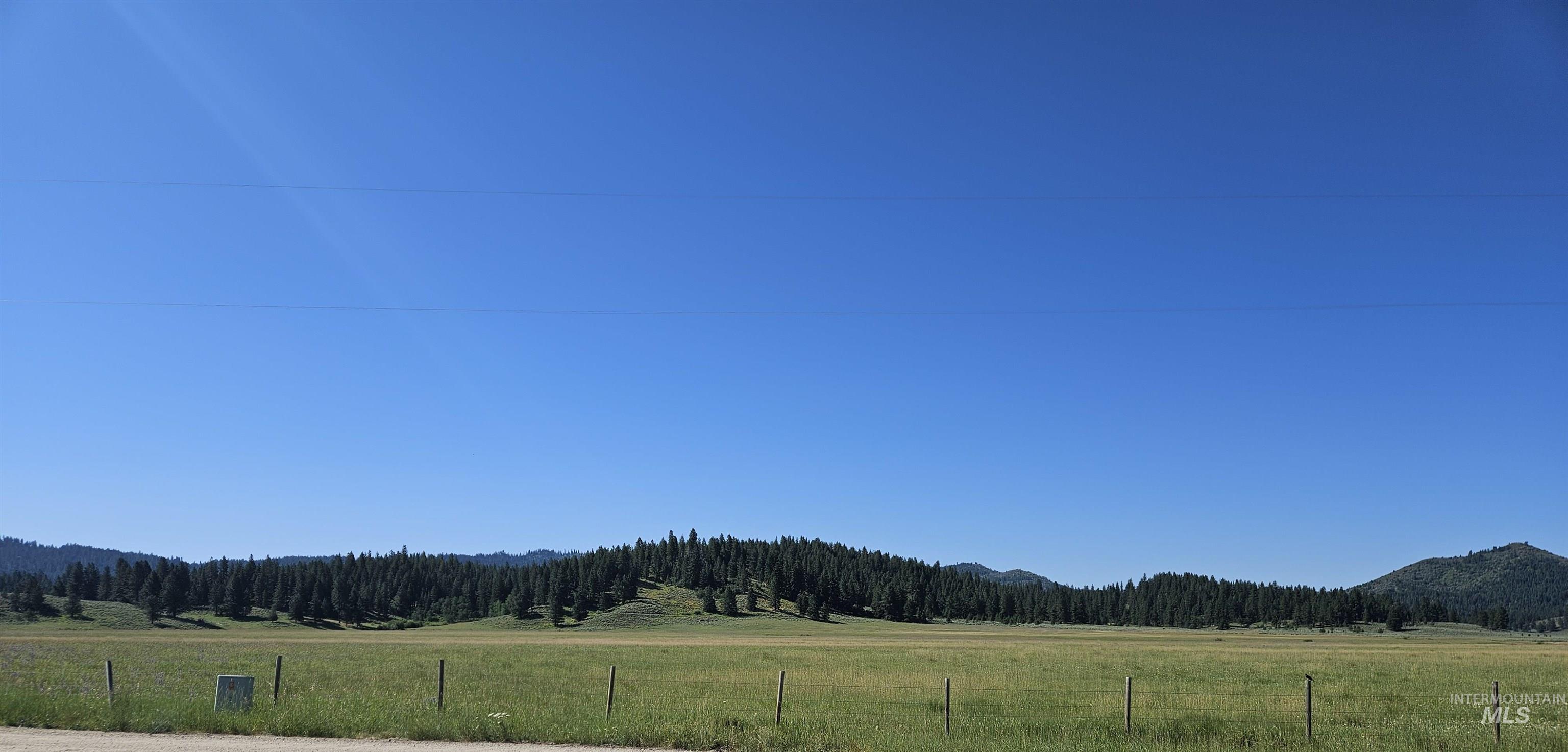 View of mountain background featuring a forest and rural landscape