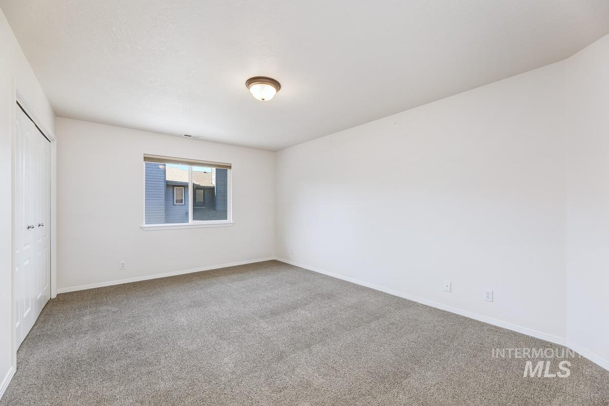 Unfurnished bedroom with carpet and a closet