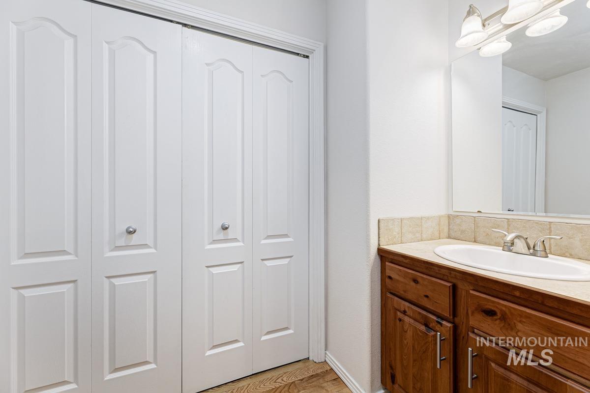 Bathroom featuring a closet and vanity