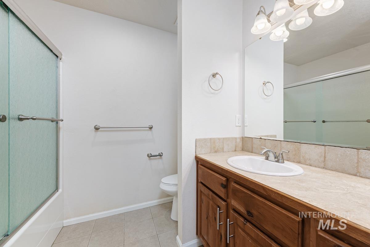 Full bath featuring tile patterned flooring and vanity