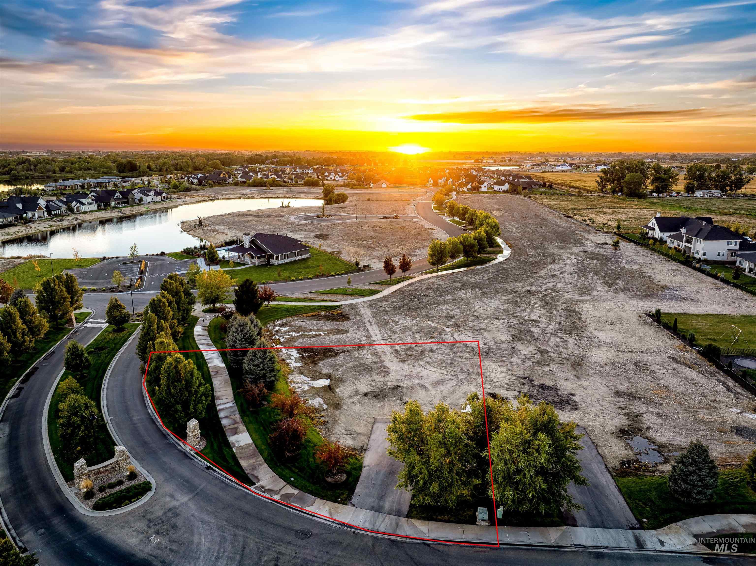 Aerial view at dusk of property parcel outlined, a residential view, and a water view