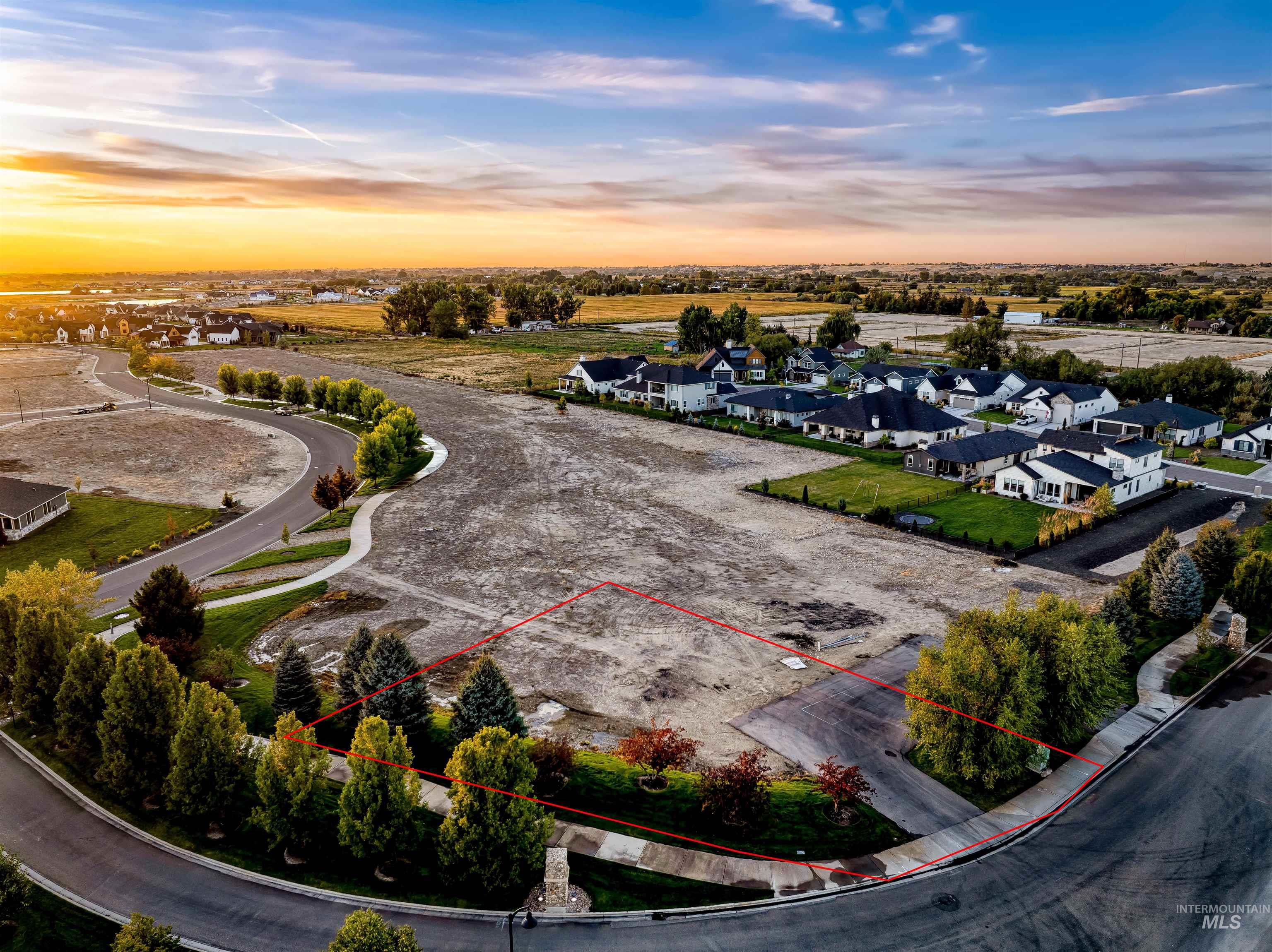 Aerial view at dusk of a residential view and property parcel outlined