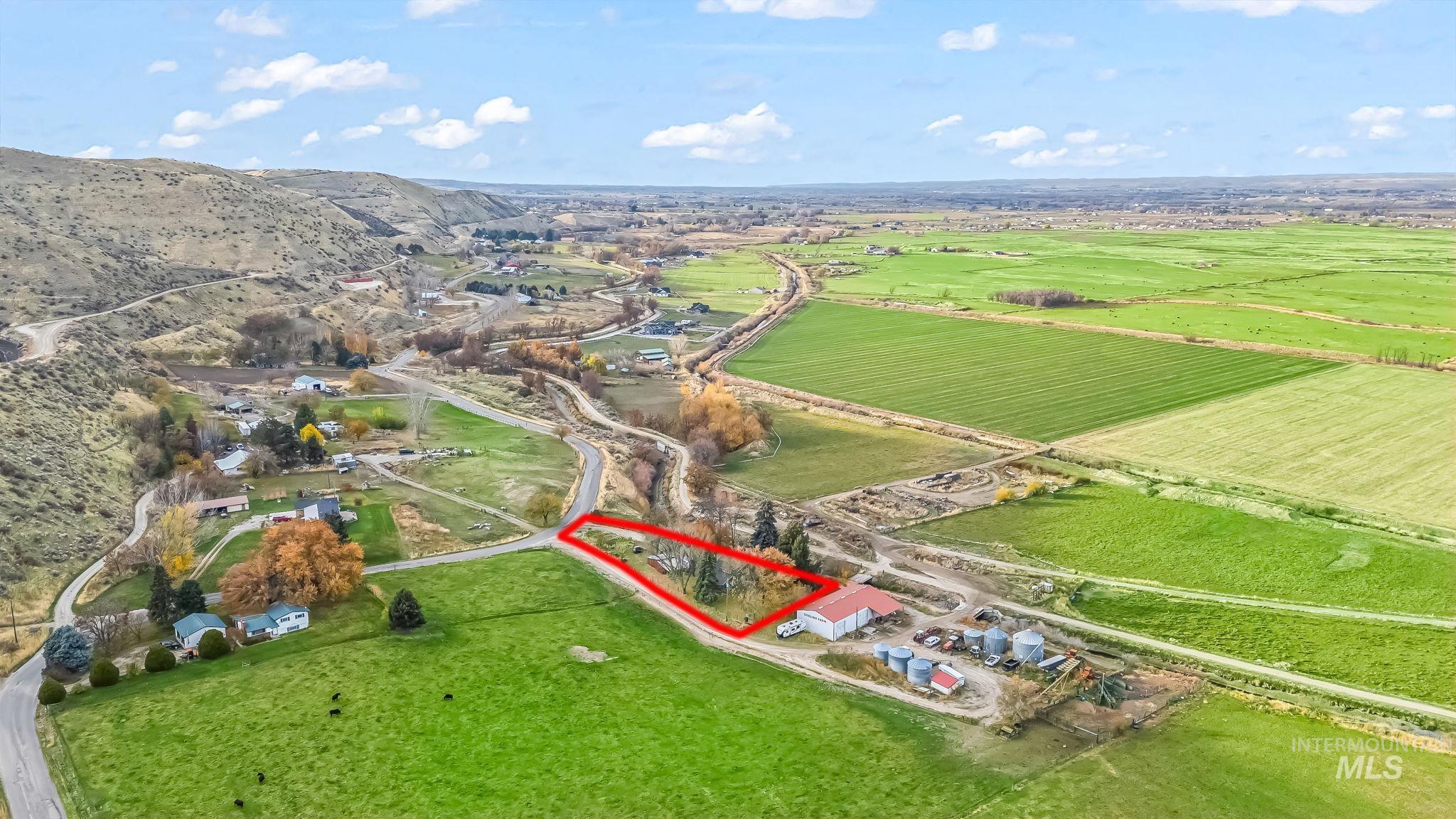 Aerial overview of property's location with rural landscape, property boundaries highlighted, and rows of crops