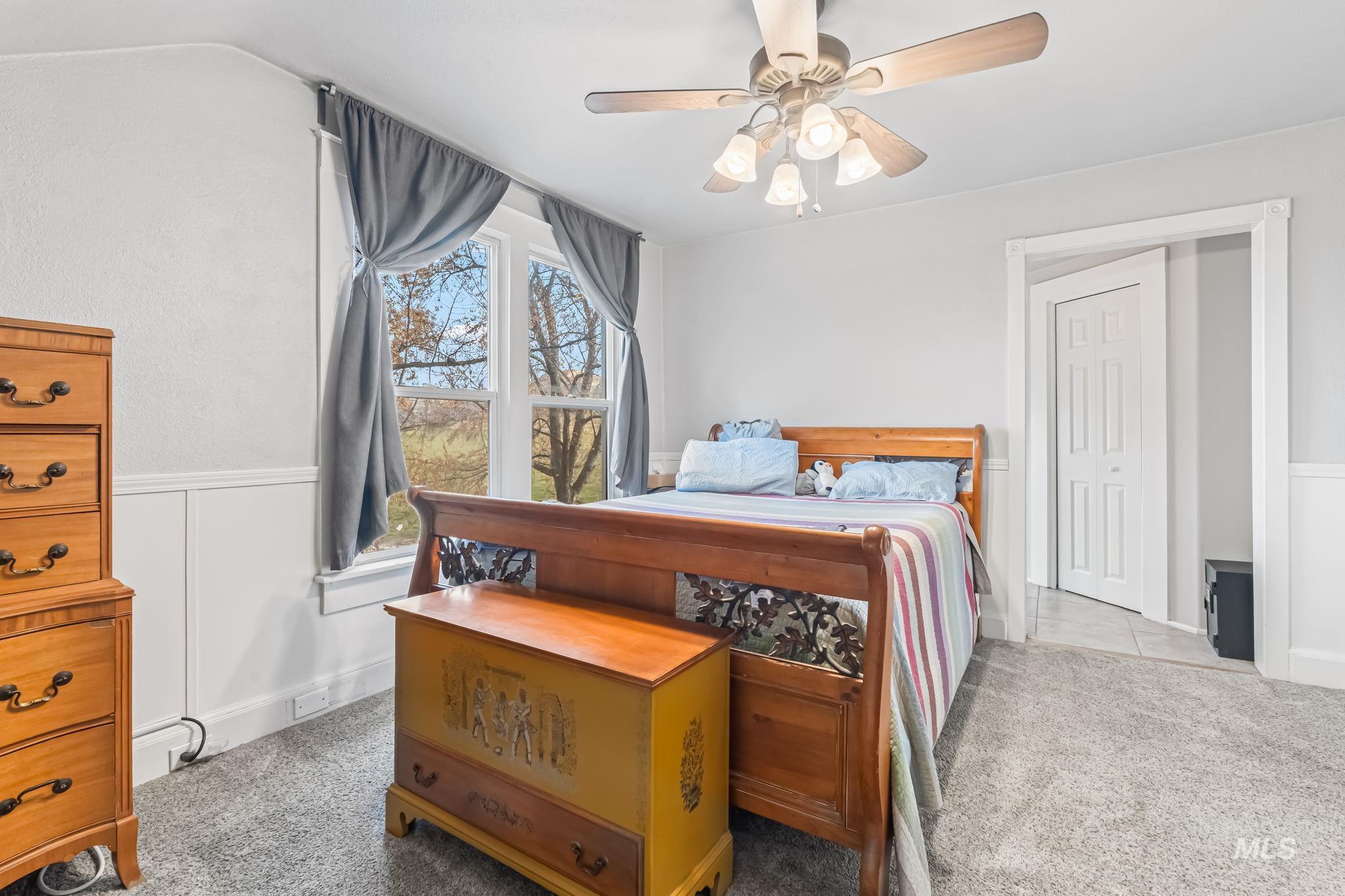 Bedroom featuring ceiling fan and light colored carpet