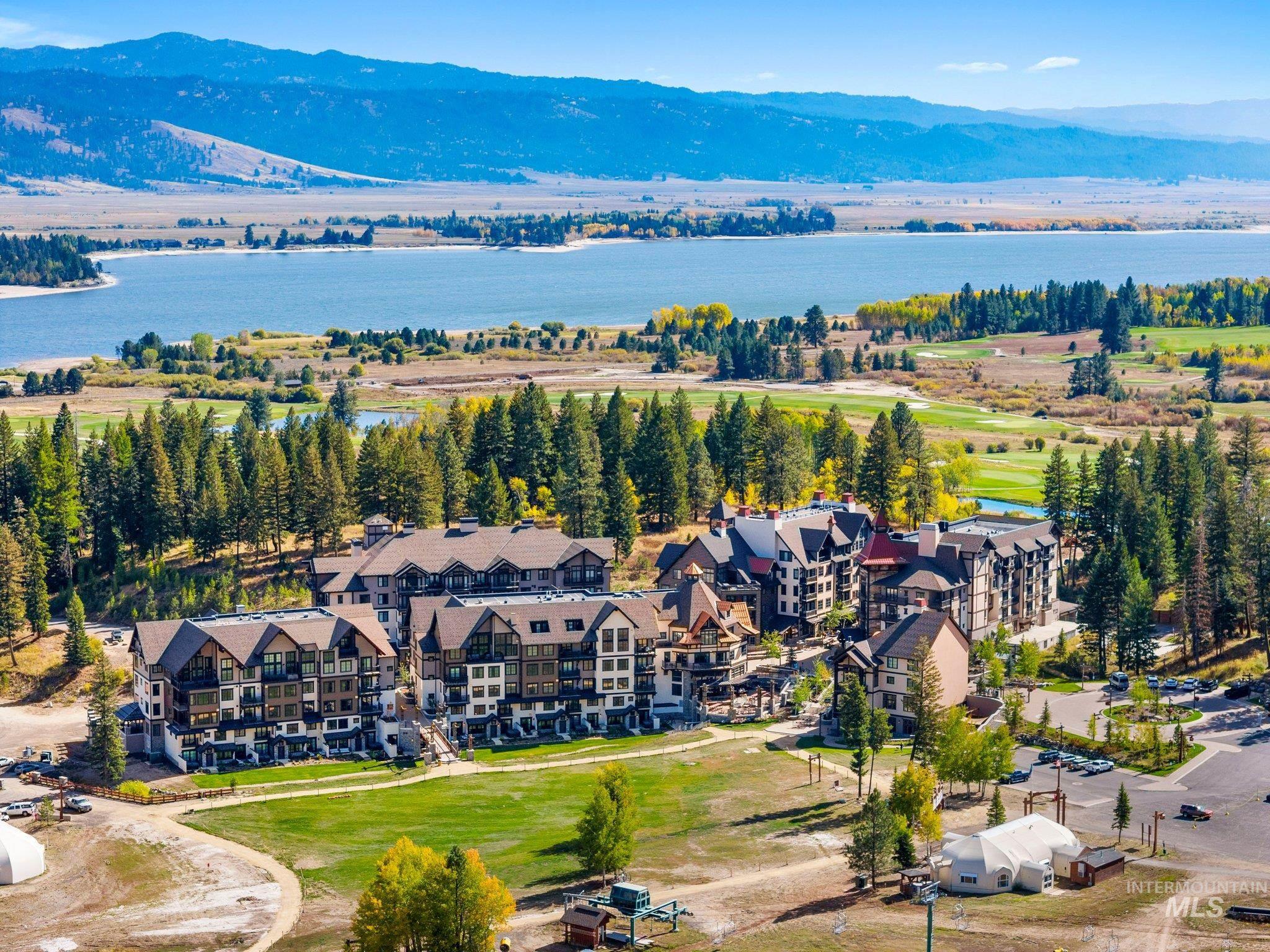 Expansive property featuring multiple multi-story buildings with varied architectural styles, pitched roofs, and exterior balconies