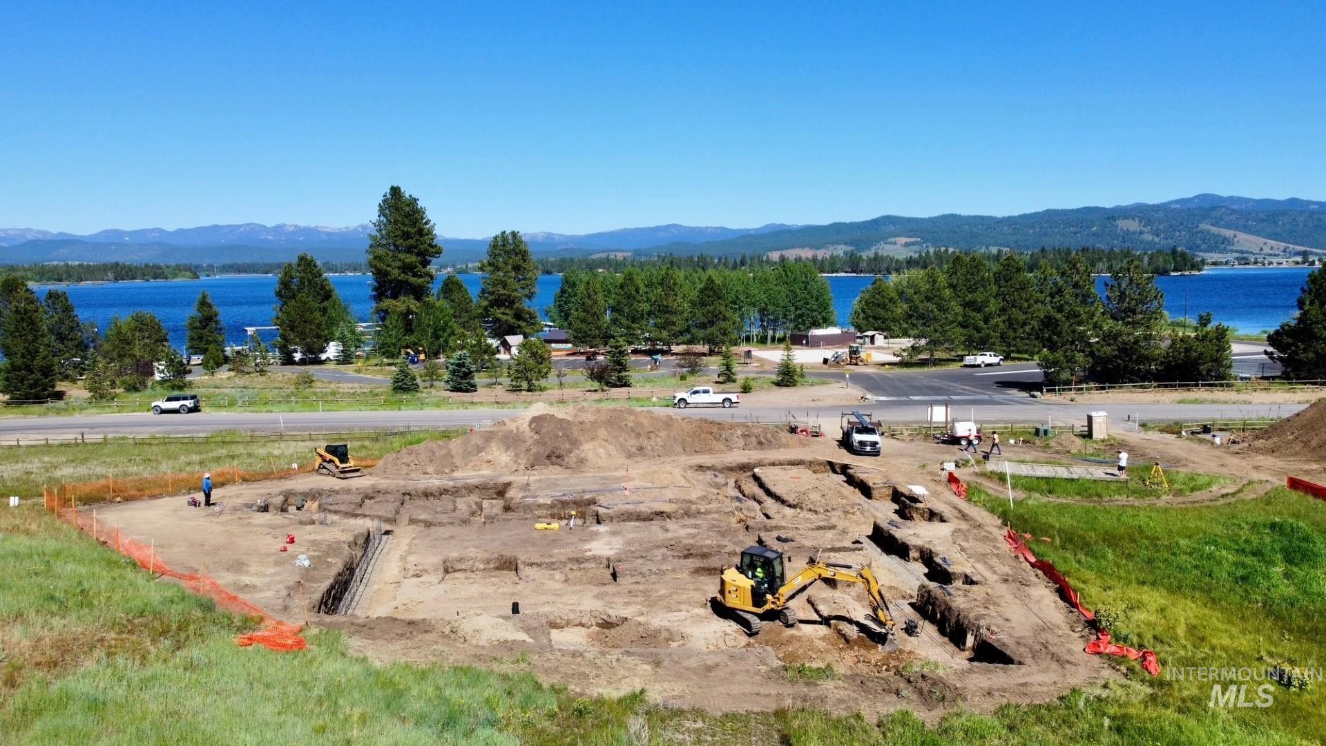 Expansive land parcel with excavation in progress, offering a direct perspective of the lake and distant mountains