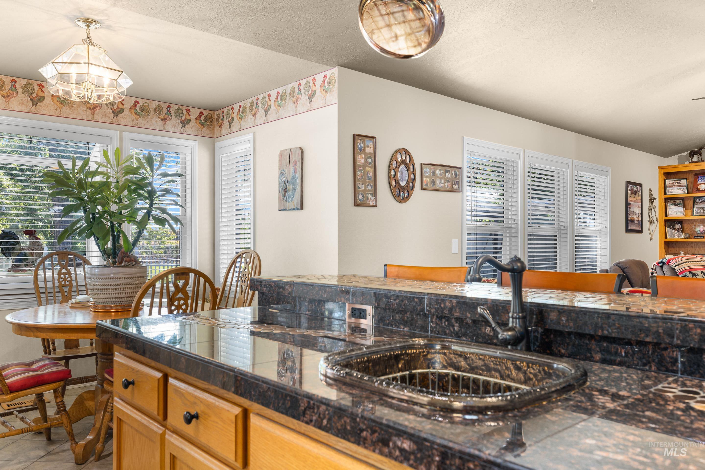 Kitchen with tile counters and decorative light fixtures