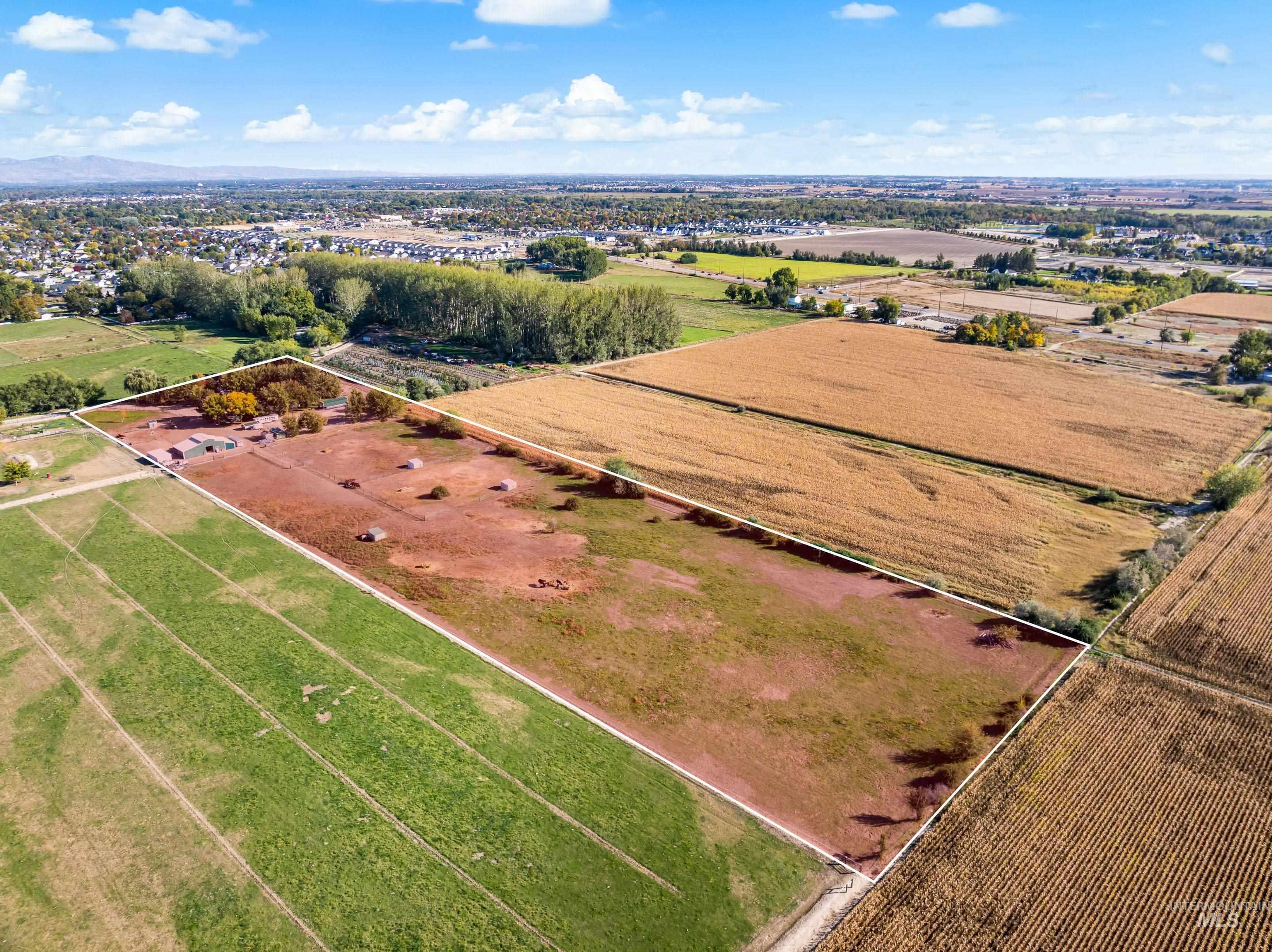 Aerial view of sparsely populated area with rows of crops
