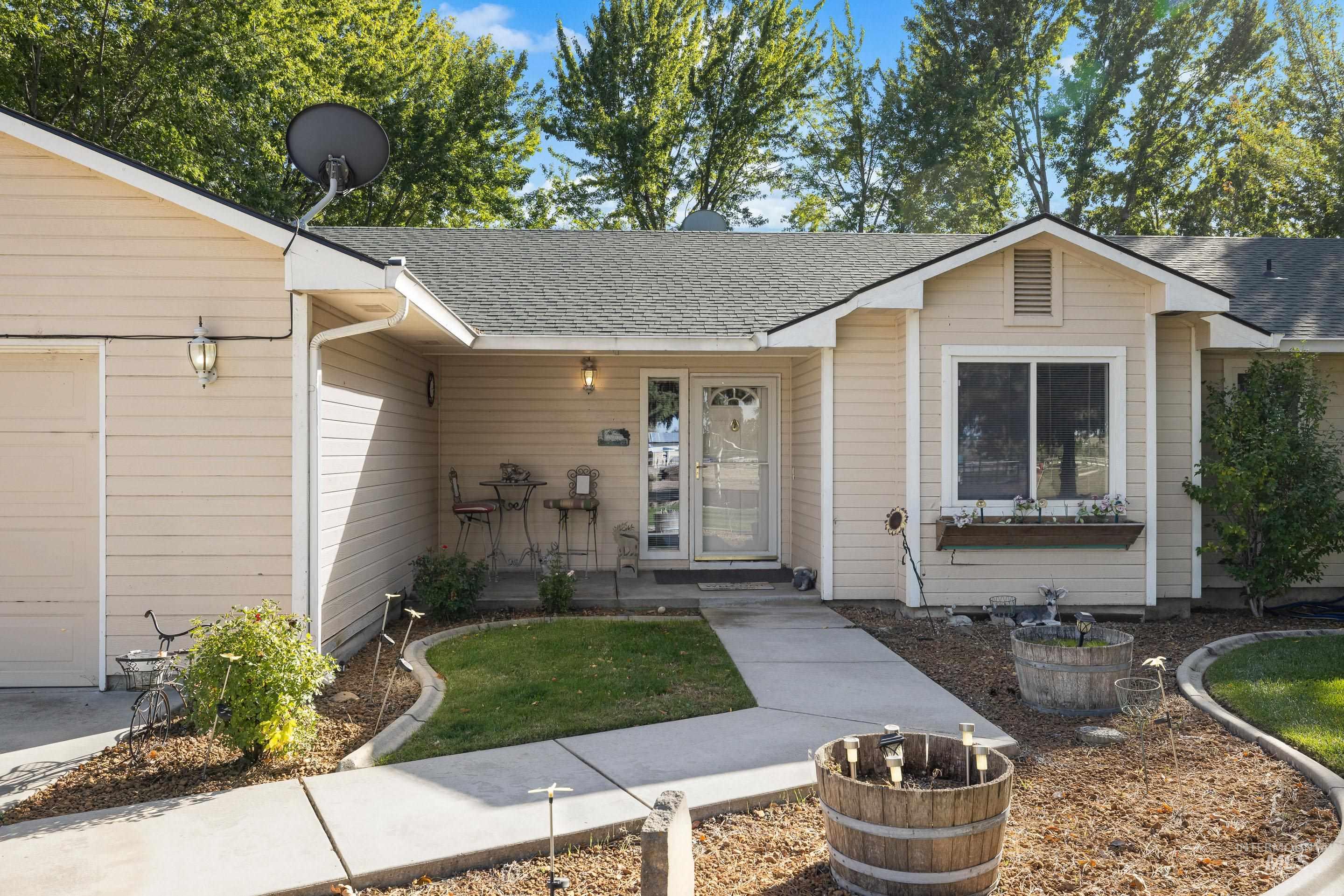 View of front of home with a shingled roof and an attached garage