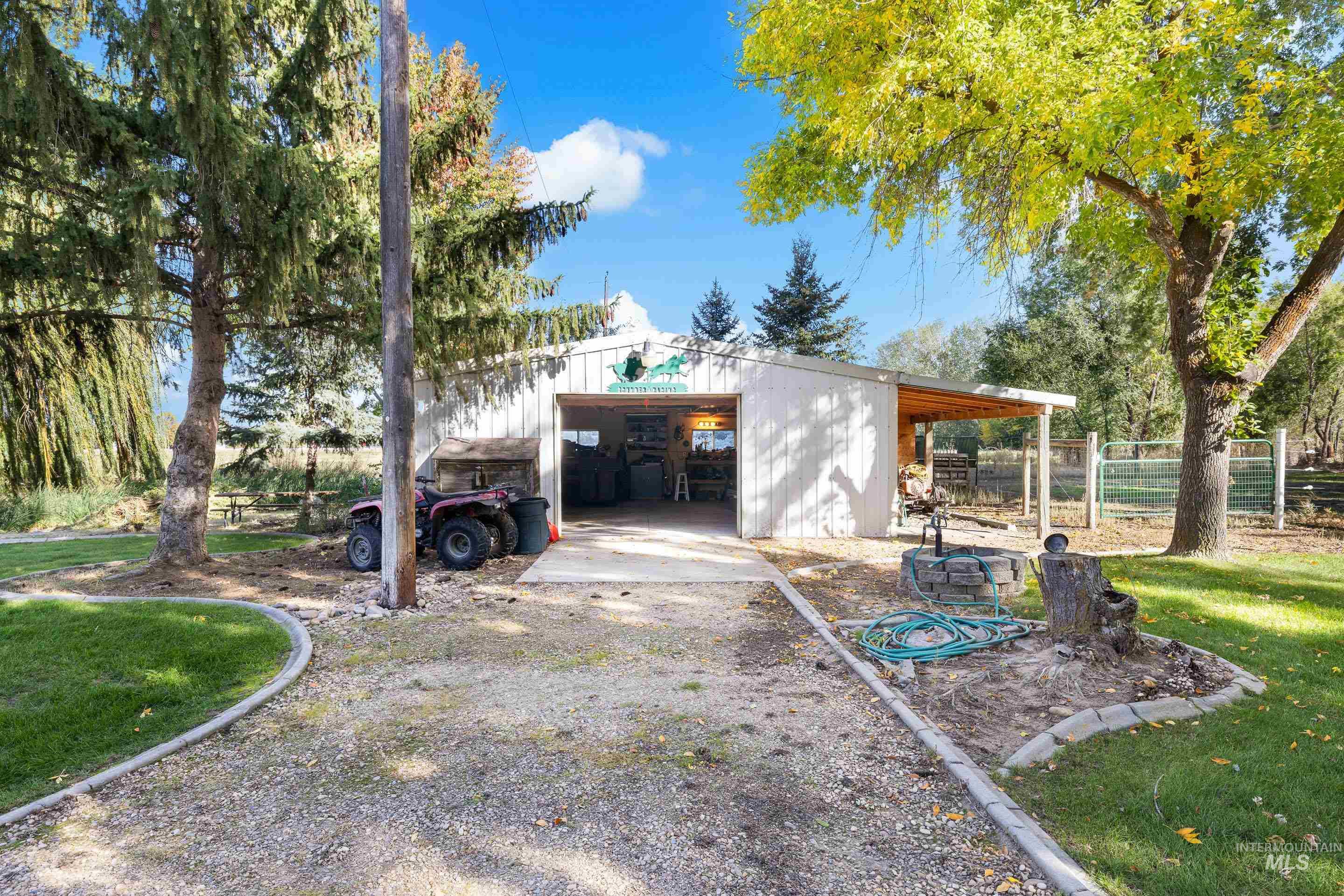 View of side of property with an outbuilding and a detached garage