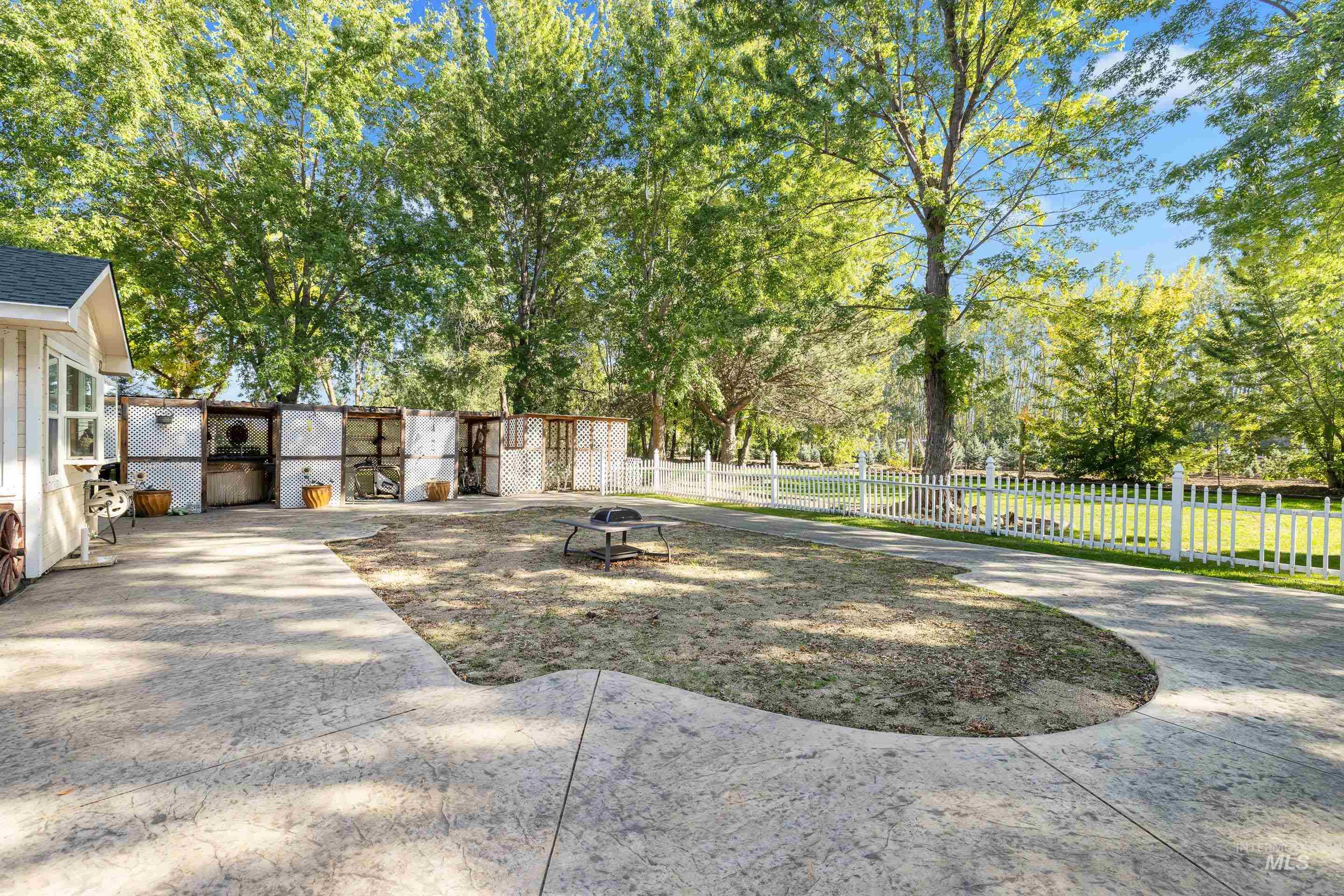 View of yard featuring view of wooded area and a fire pit