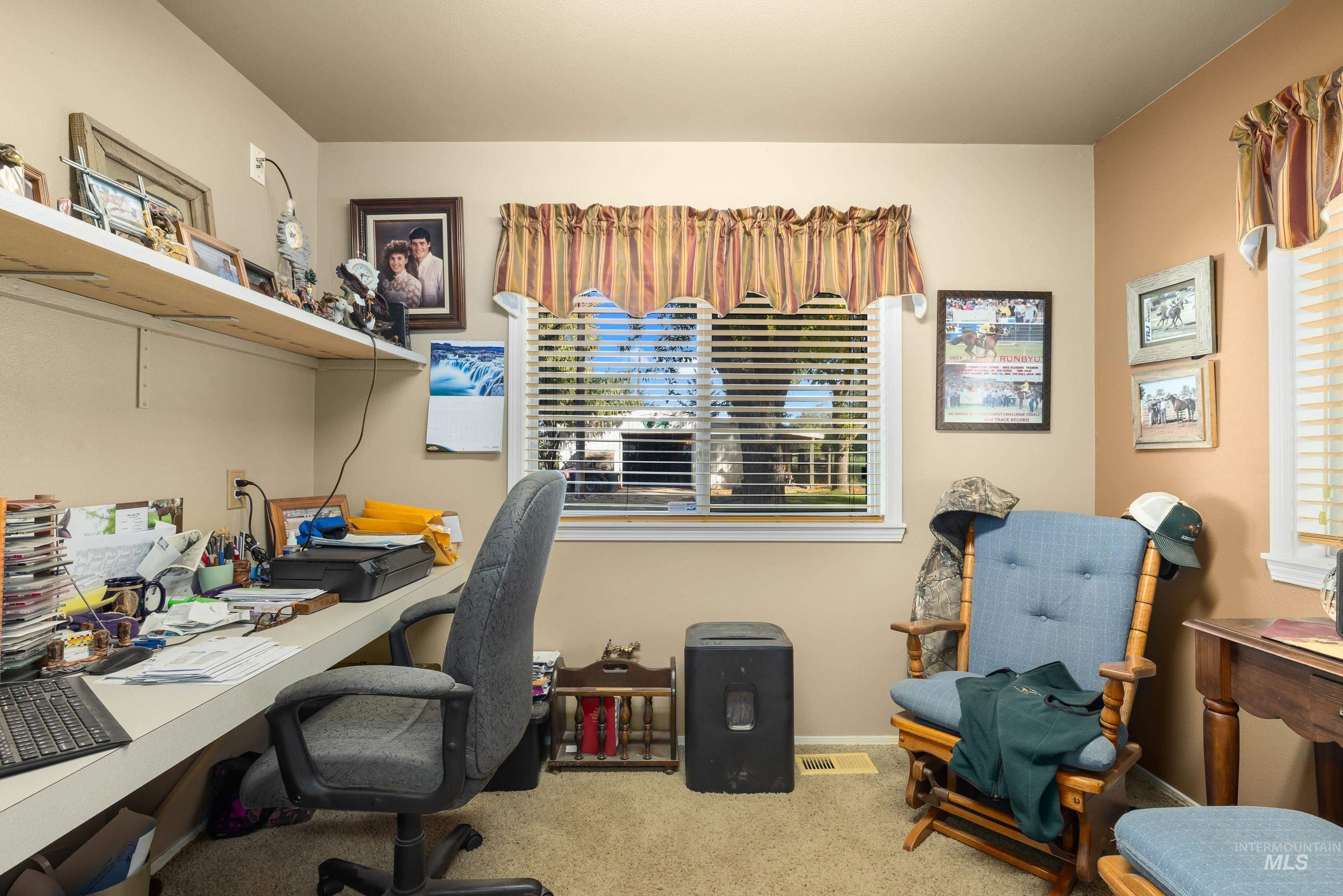 Office featuring light carpet and baseboards