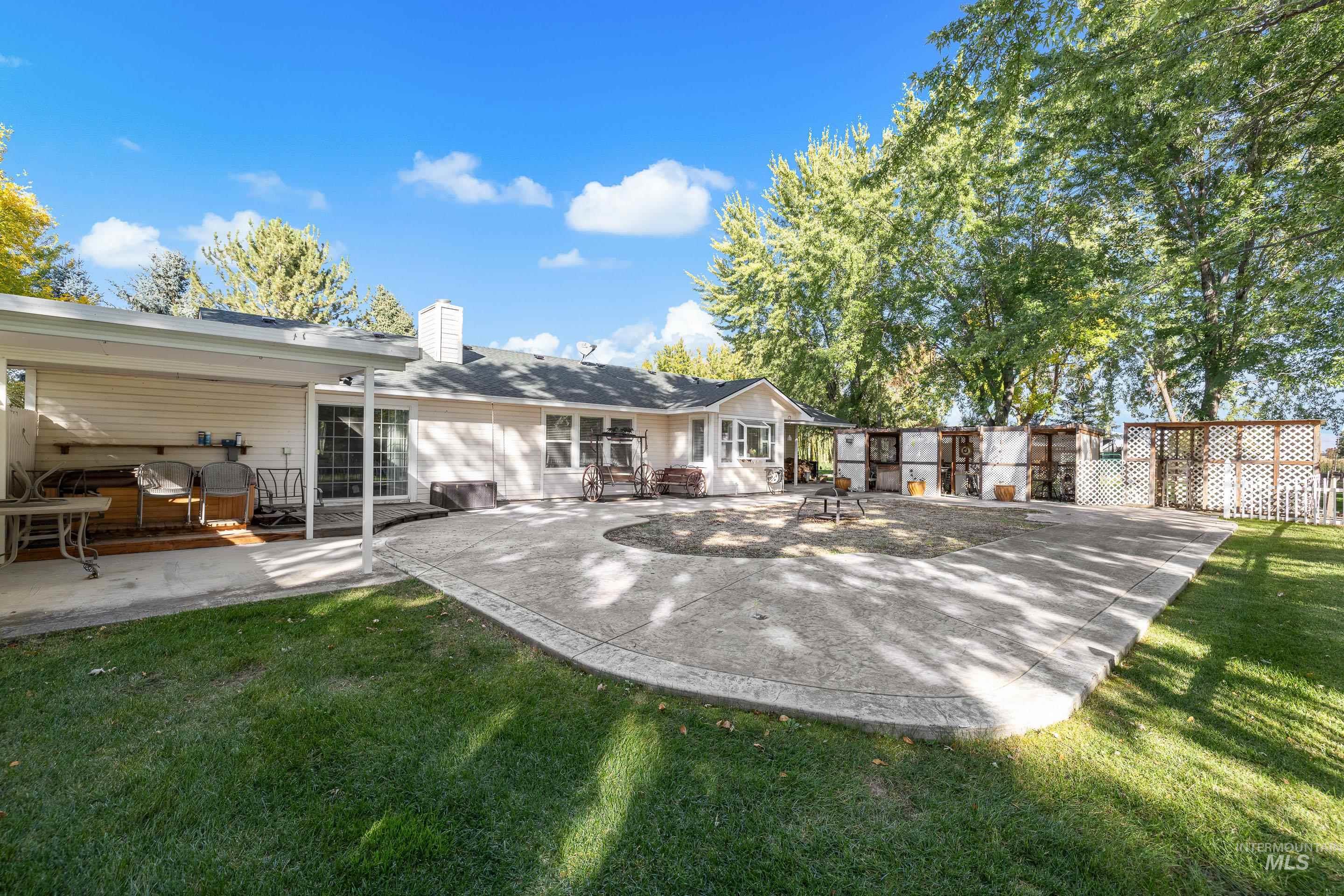 Back of house with a patio area and a chimney