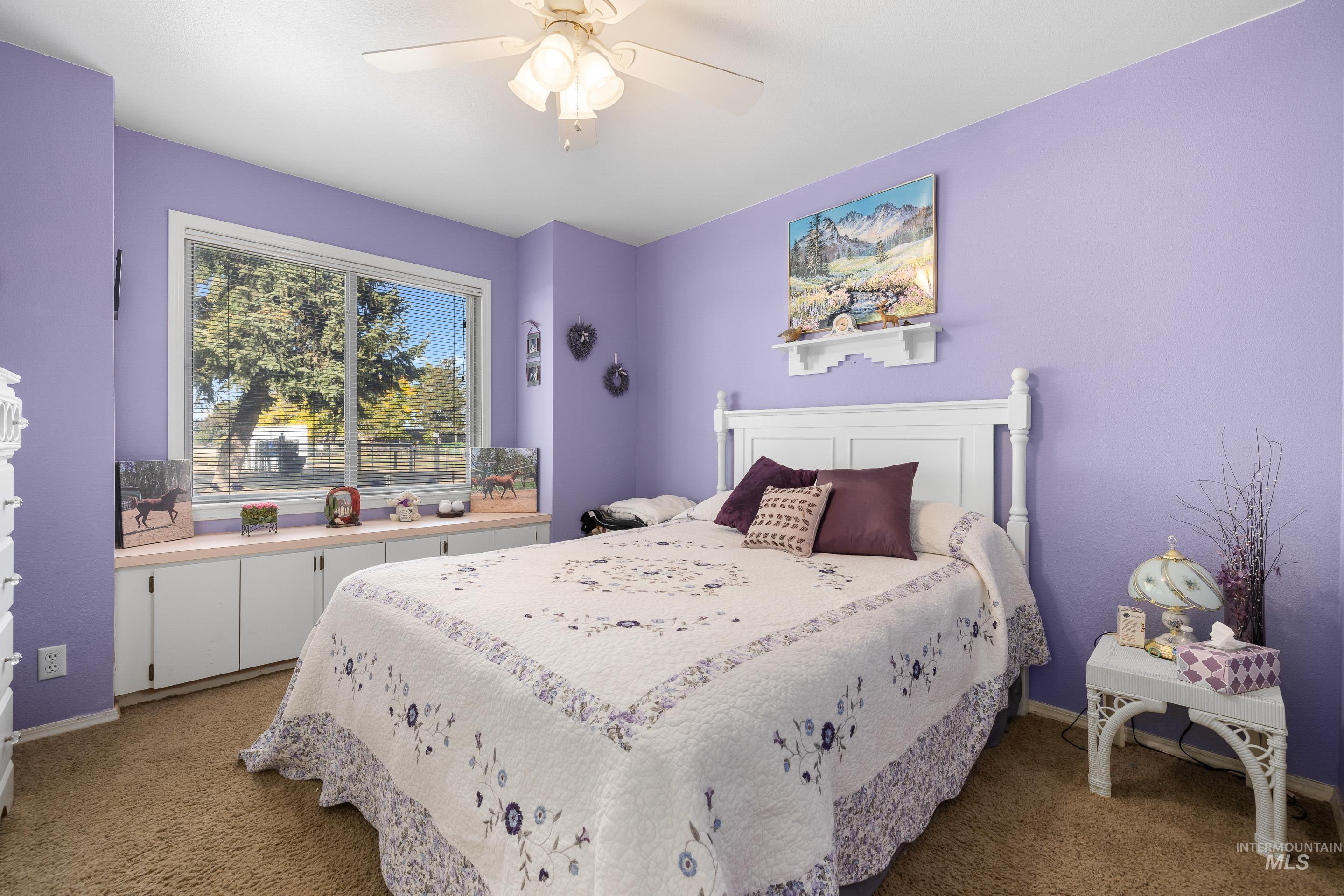 Bedroom with carpet and a ceiling fan