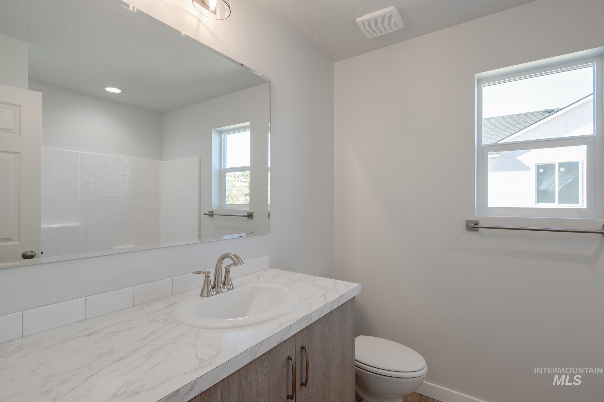Bathroom featuring vanity and toilet