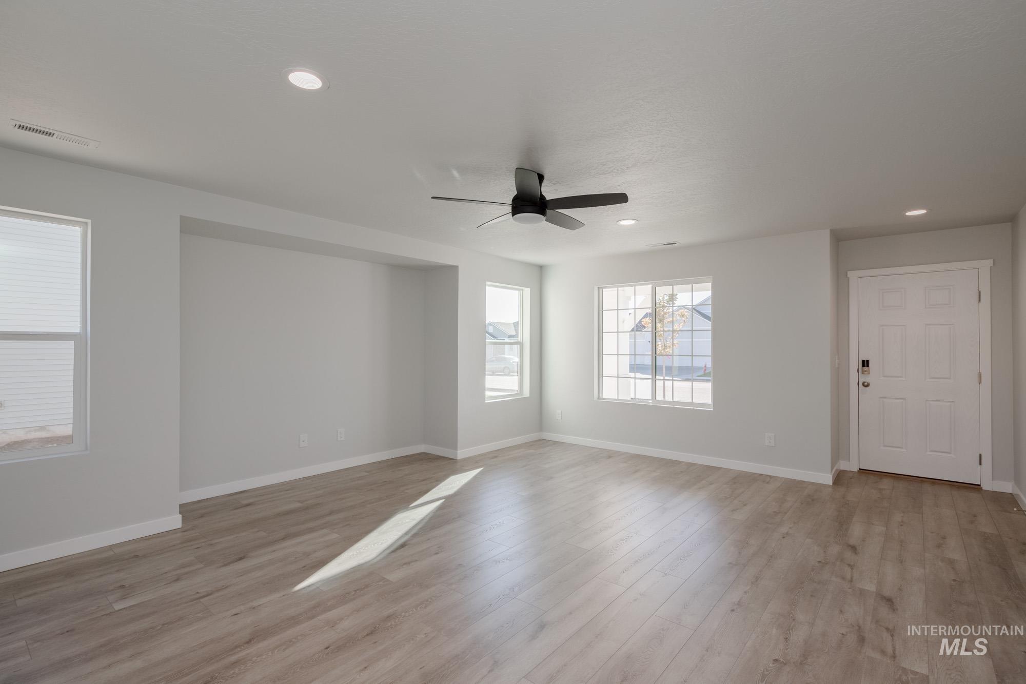 Empty room with light wood-style flooring, recessed lighting, and ceiling fan