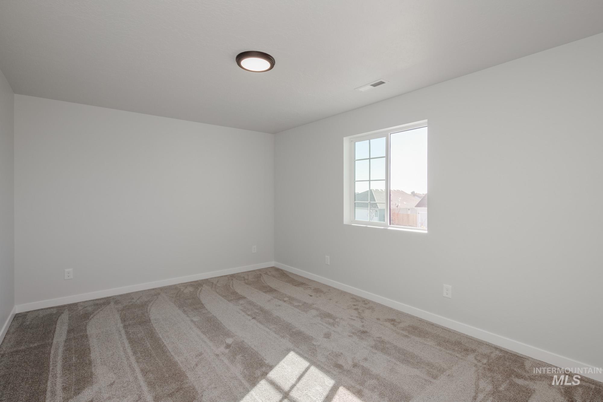 Unfurnished room featuring carpet flooring and baseboards