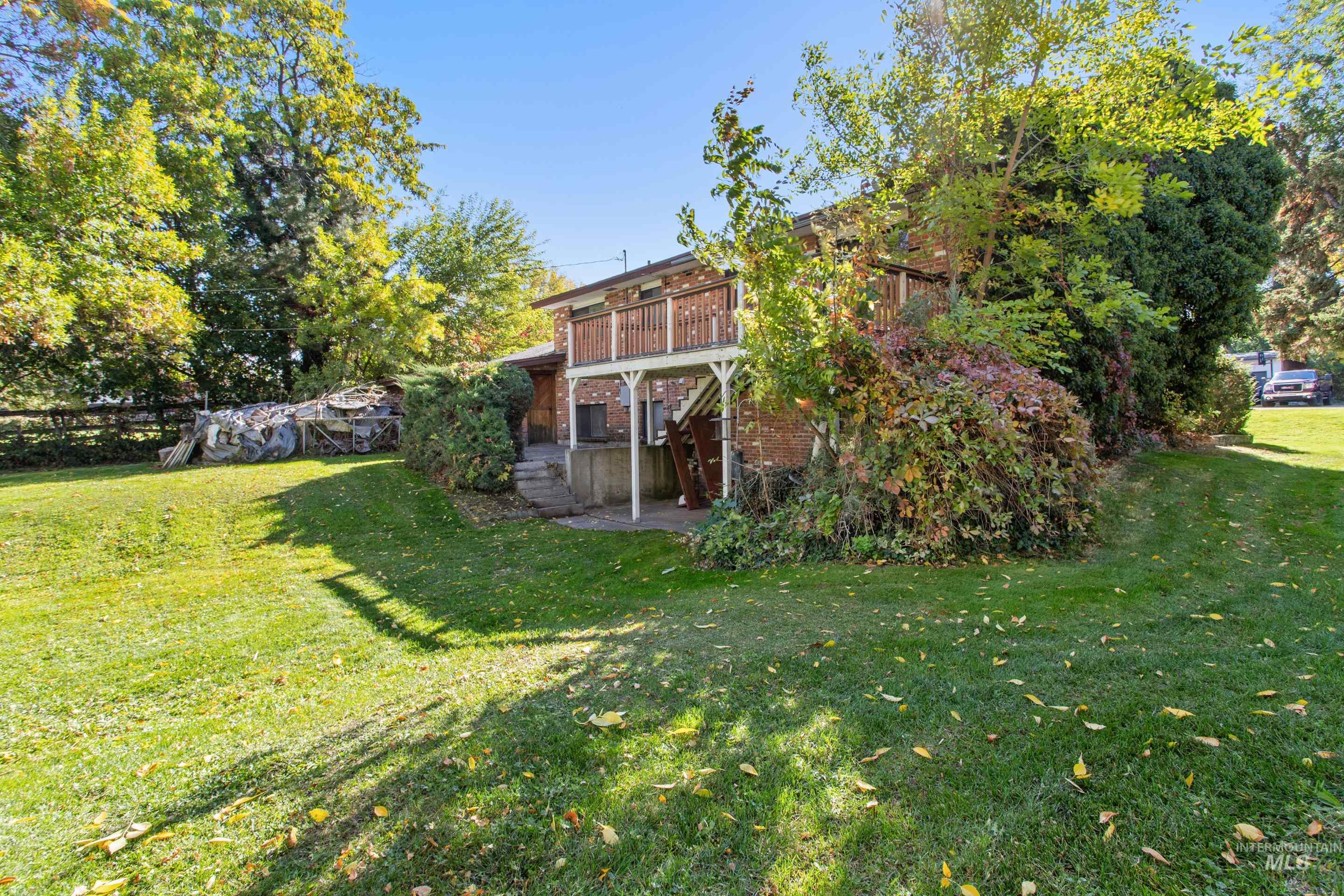 View of grassy yard featuring a patio