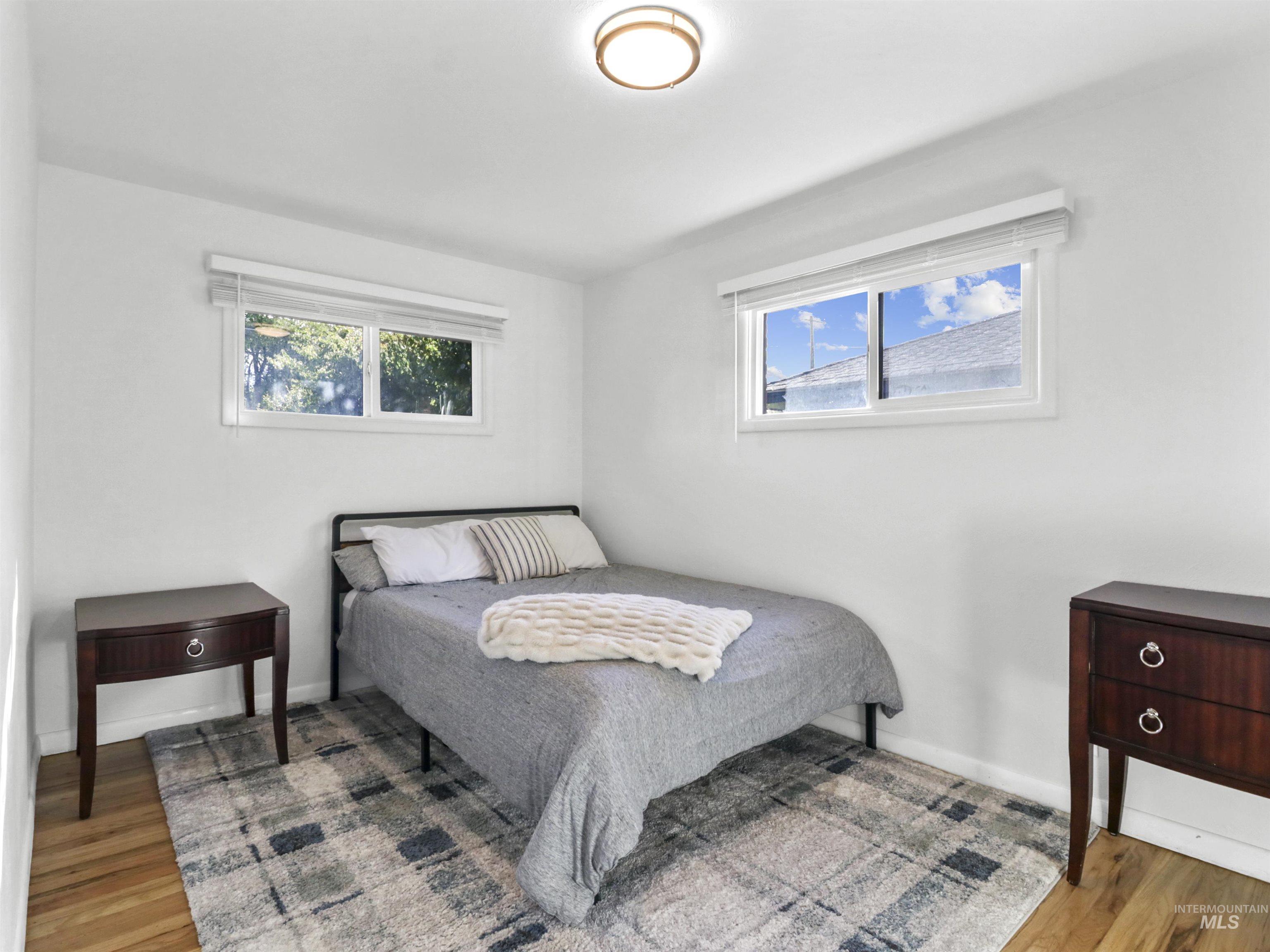 Bedroom featuring wood finished floors and baseboards