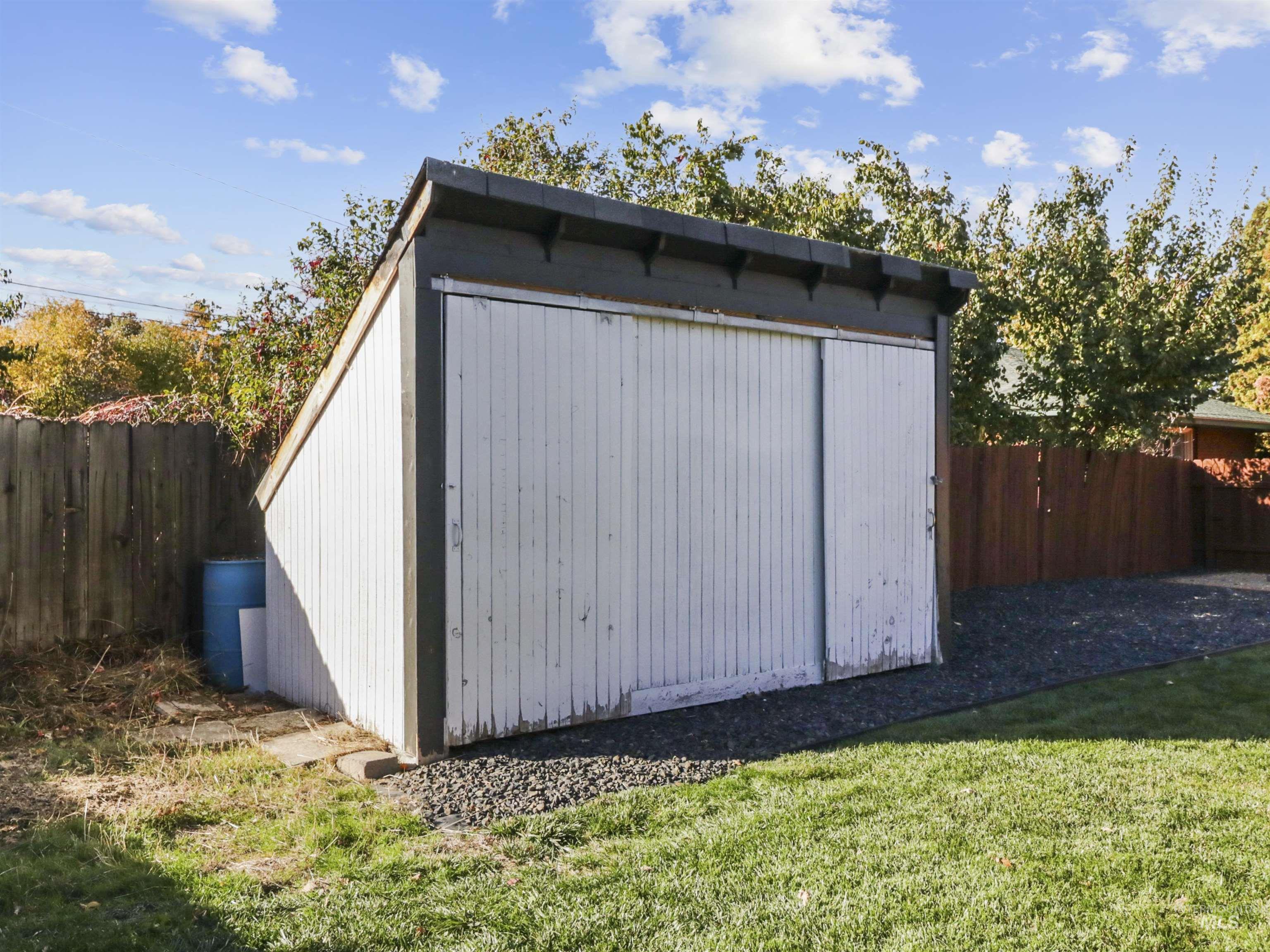View of shed with a fenced backyard