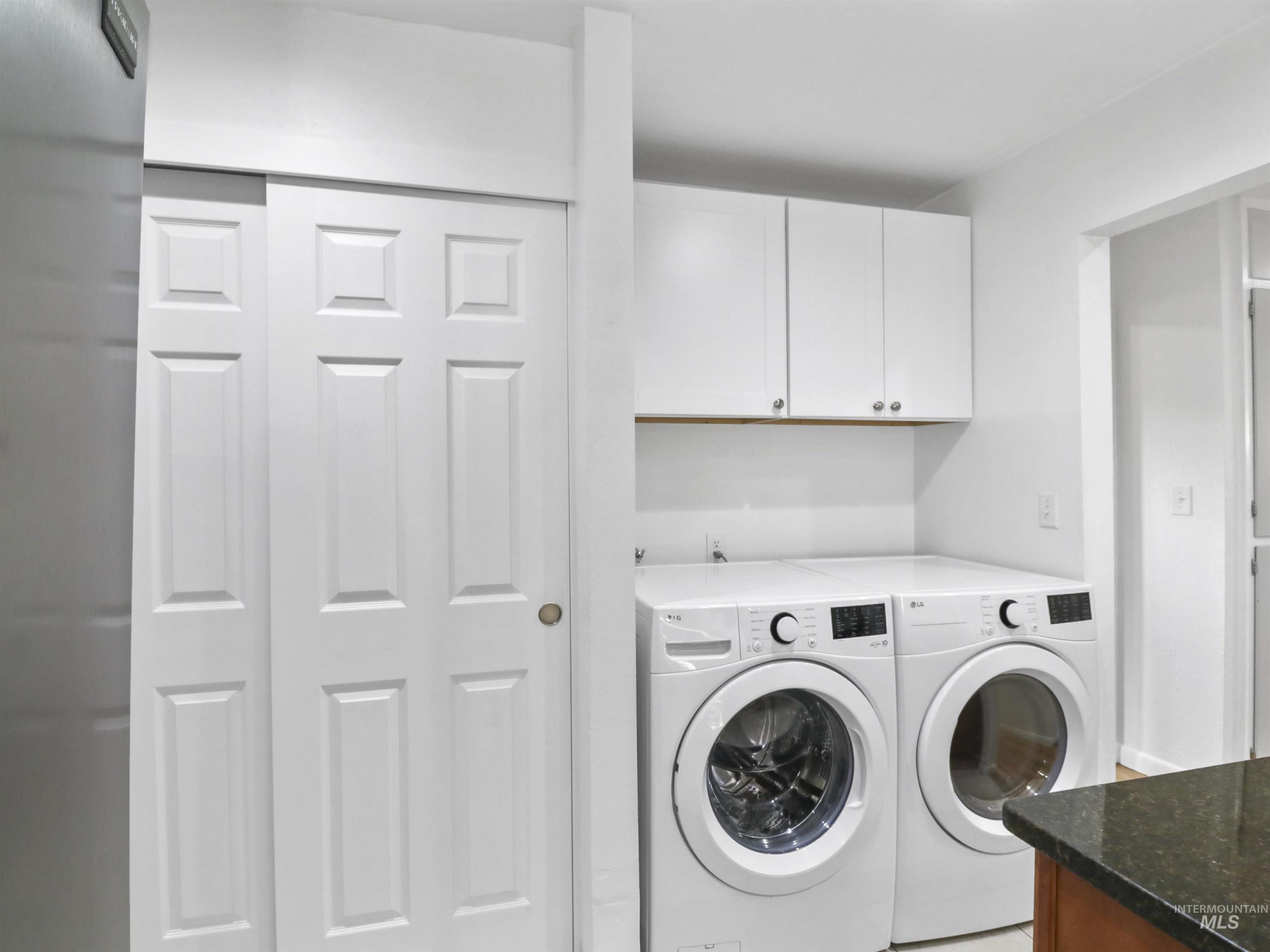 Laundry room with cabinet space and washer and dryer