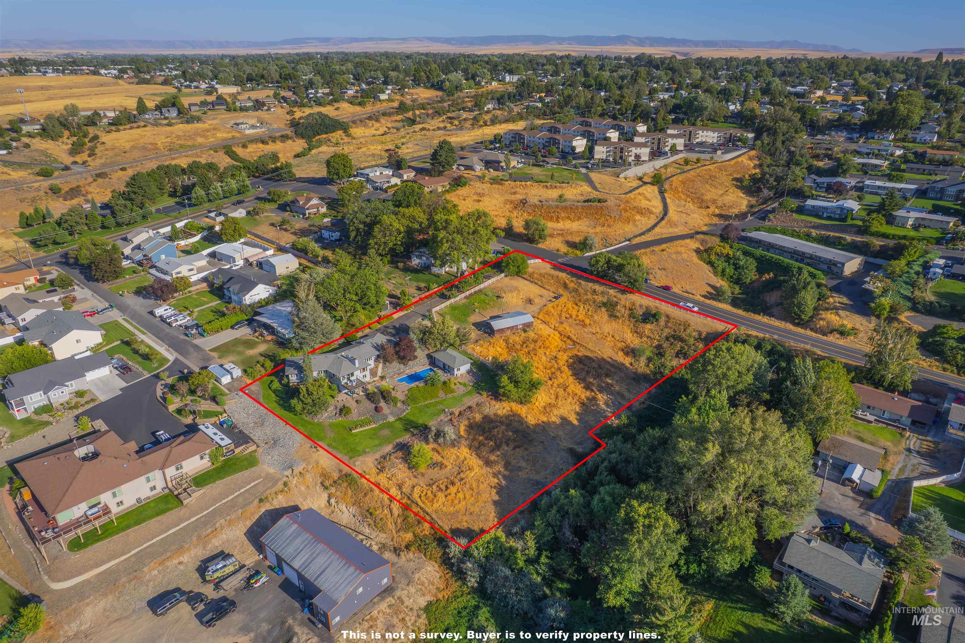 Aerial view of residential area featuring property boundaries highlighted